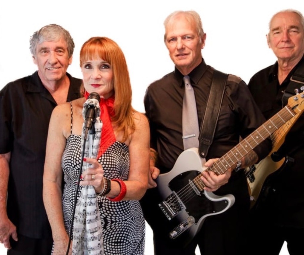 a group of people posing with guitars and microphones