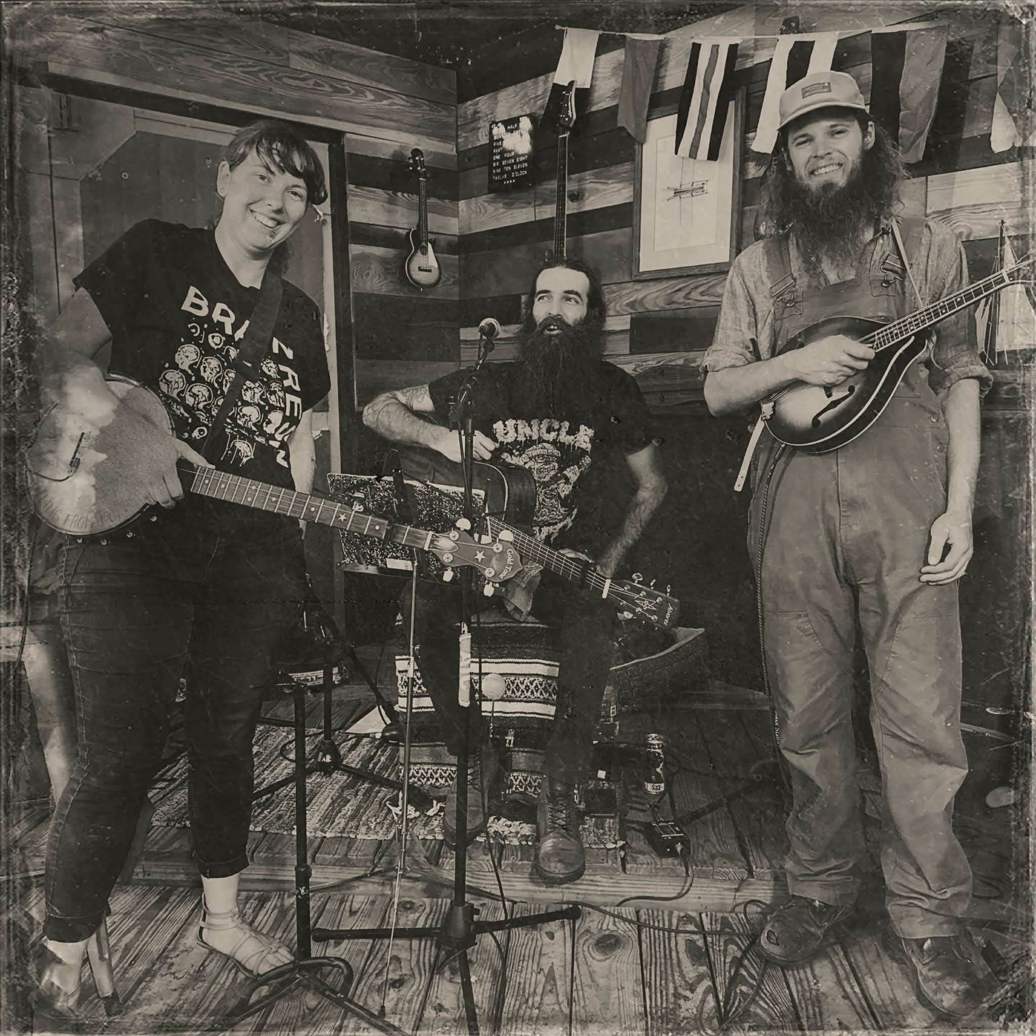 a group of people standing in a room with guitars