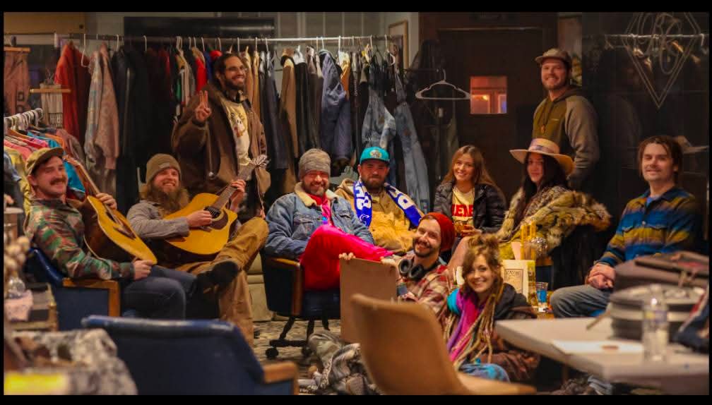 a group of people posing for a photo in a clothing store