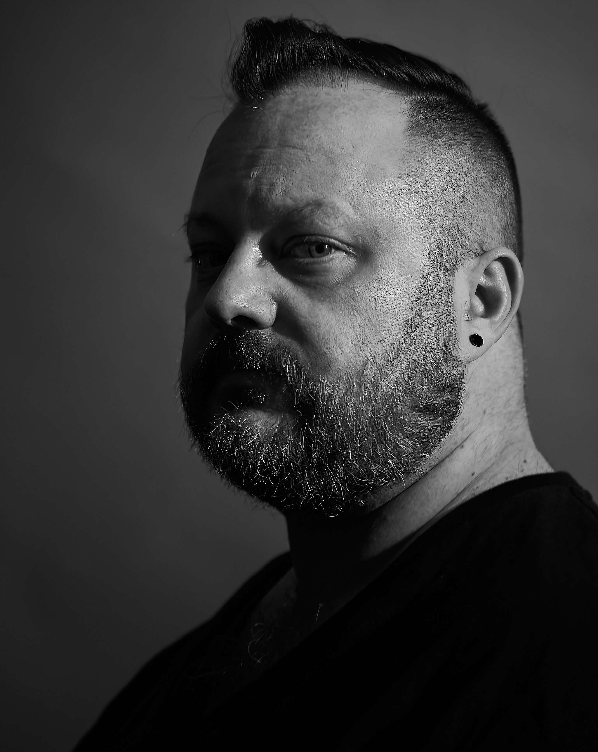 a black and white photo of a man with a beard