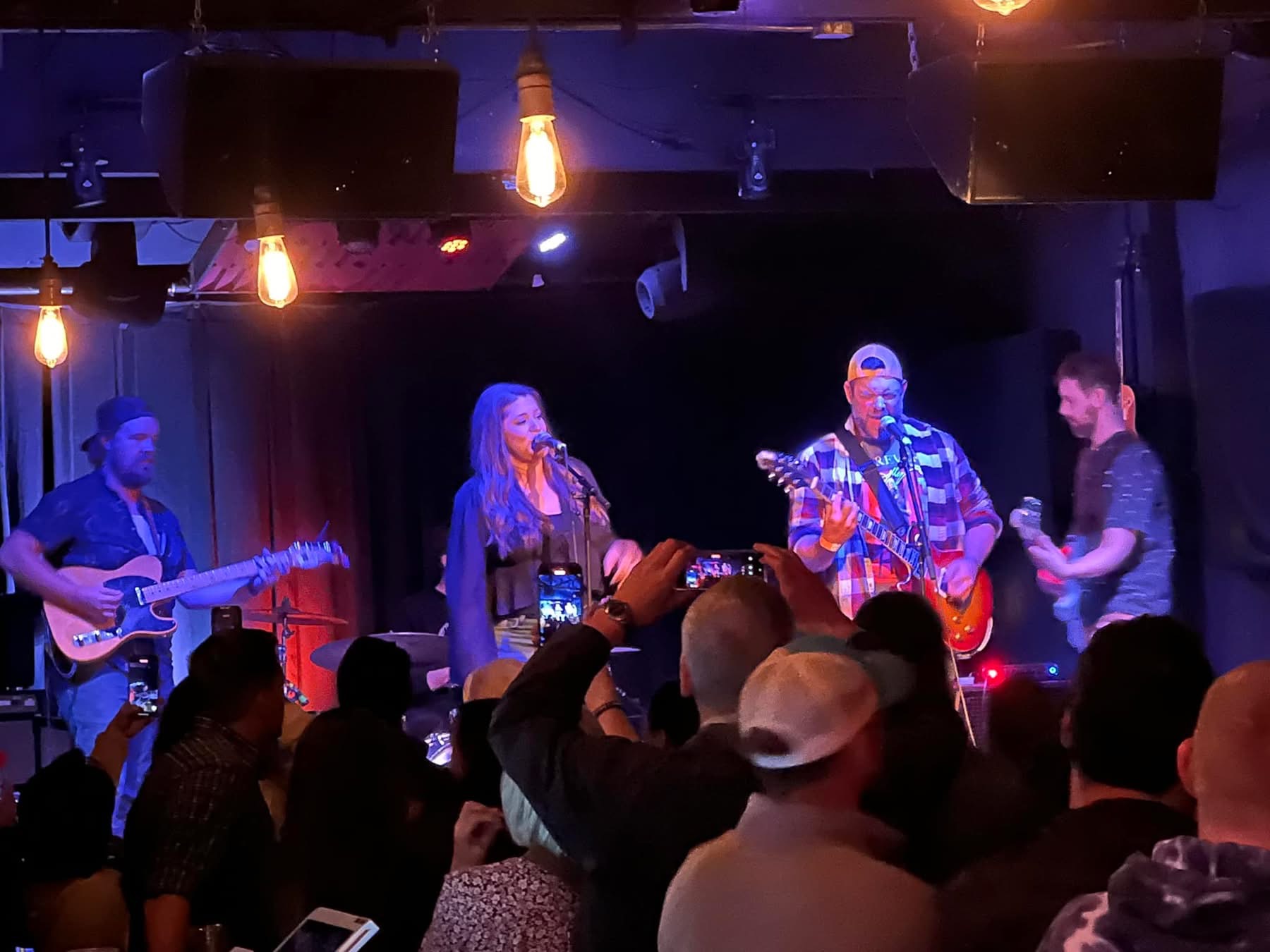 a group of people standing in front of a stage
