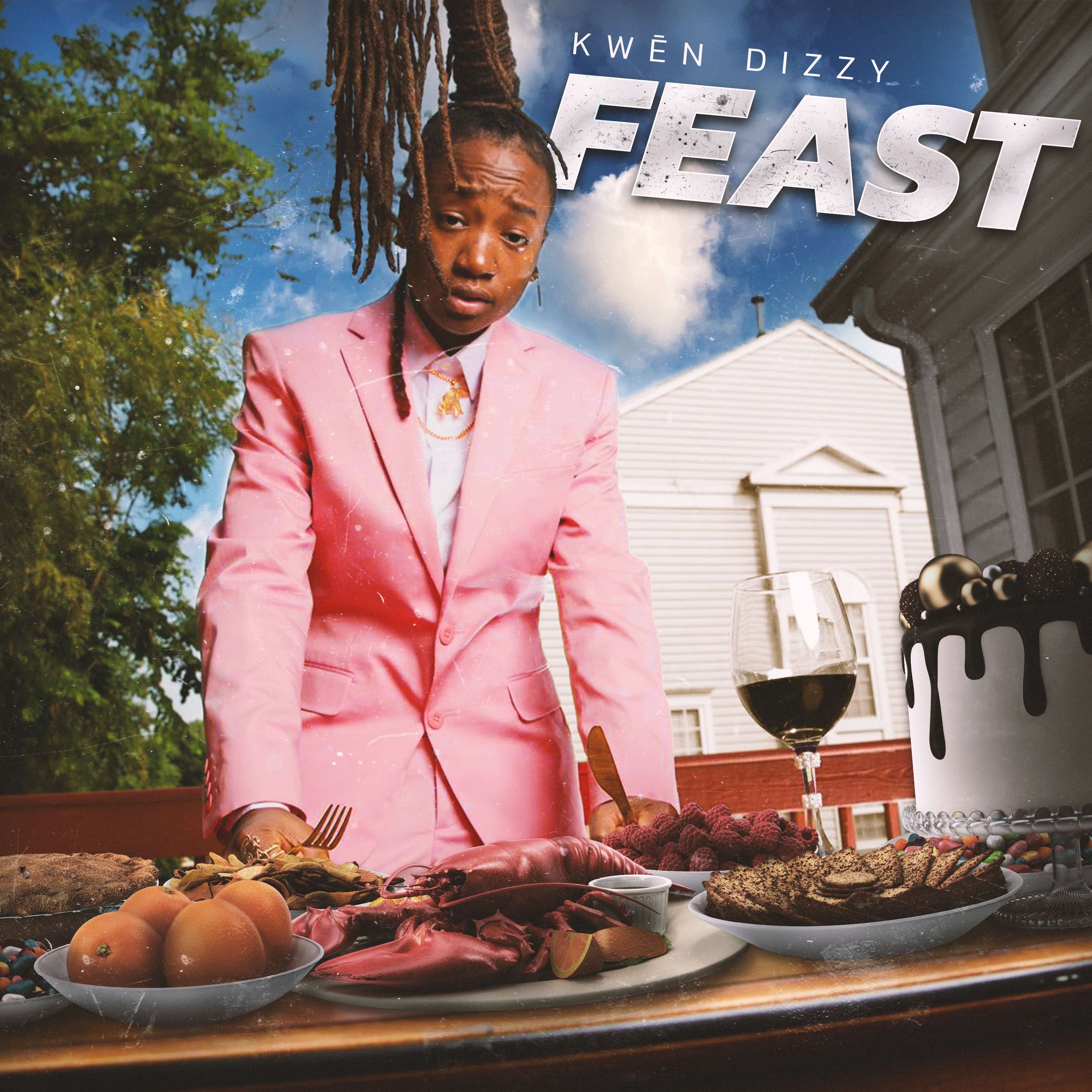 Kwēn Dizzy - FEAST: a man in a pink suit is standing next to a plate of food