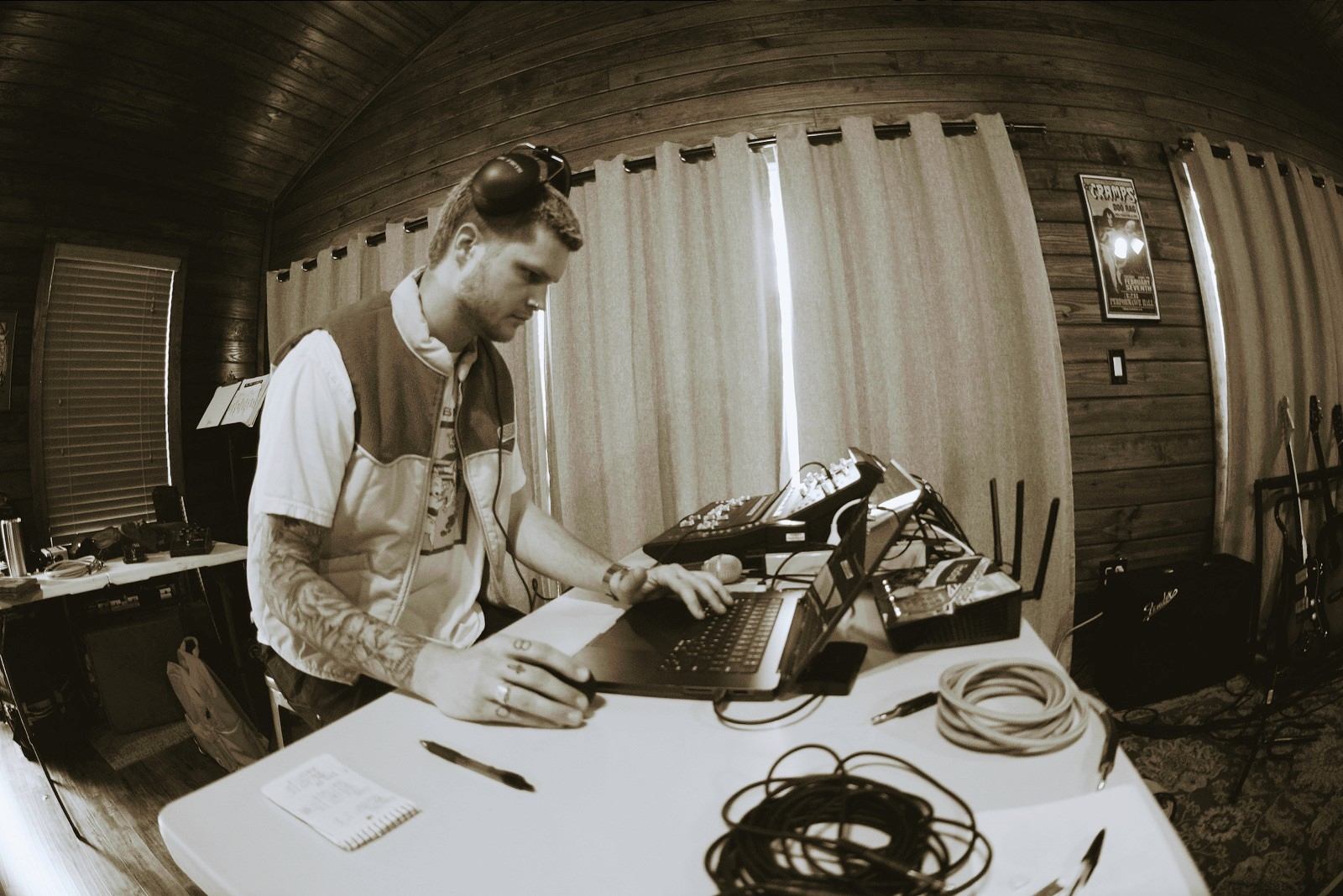 a man working on a laptop in a room