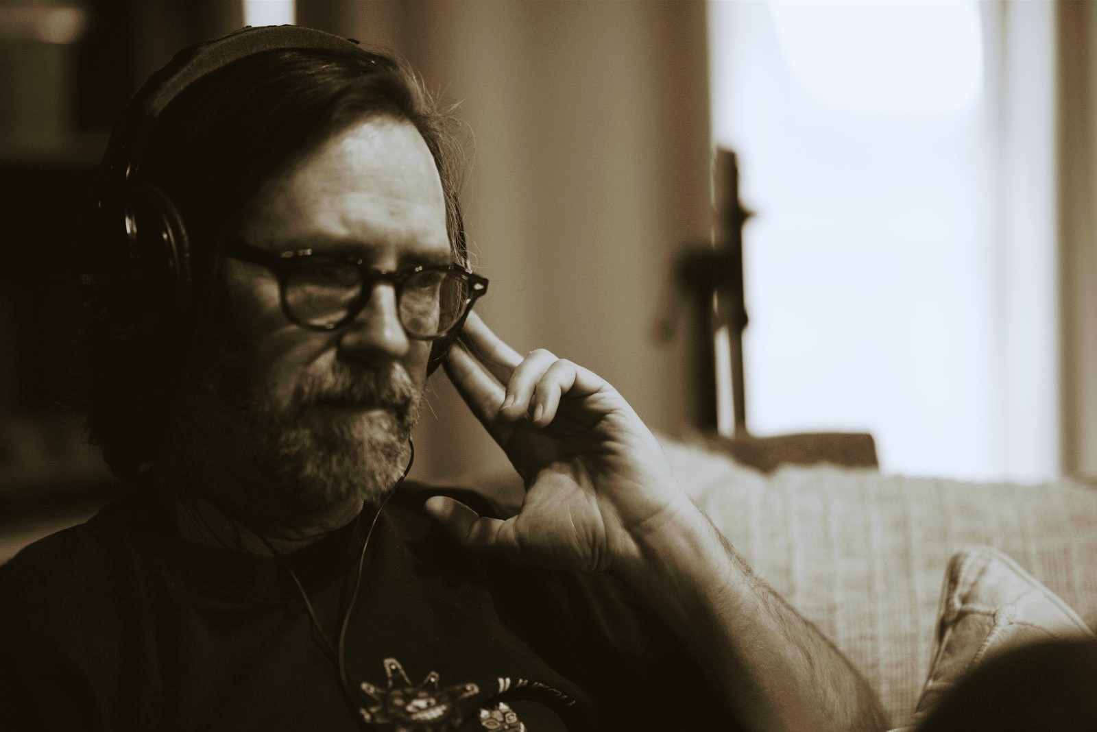 a man wearing headphones is sitting on a couch