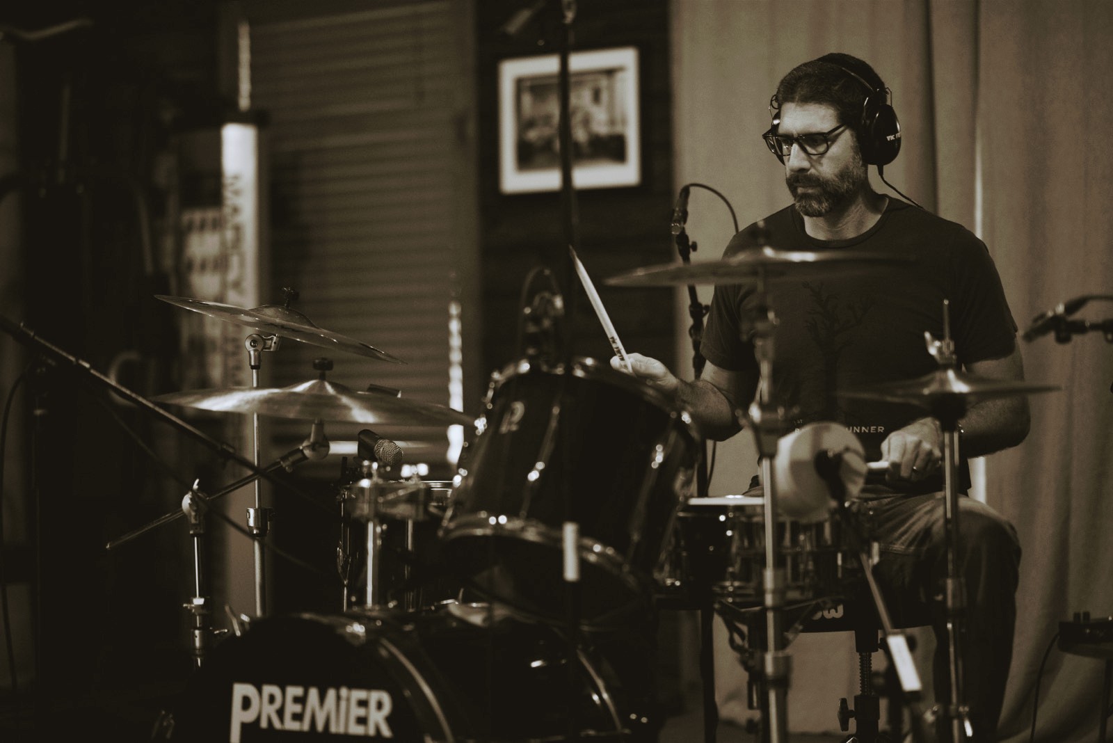 a man playing drums in a recording studio