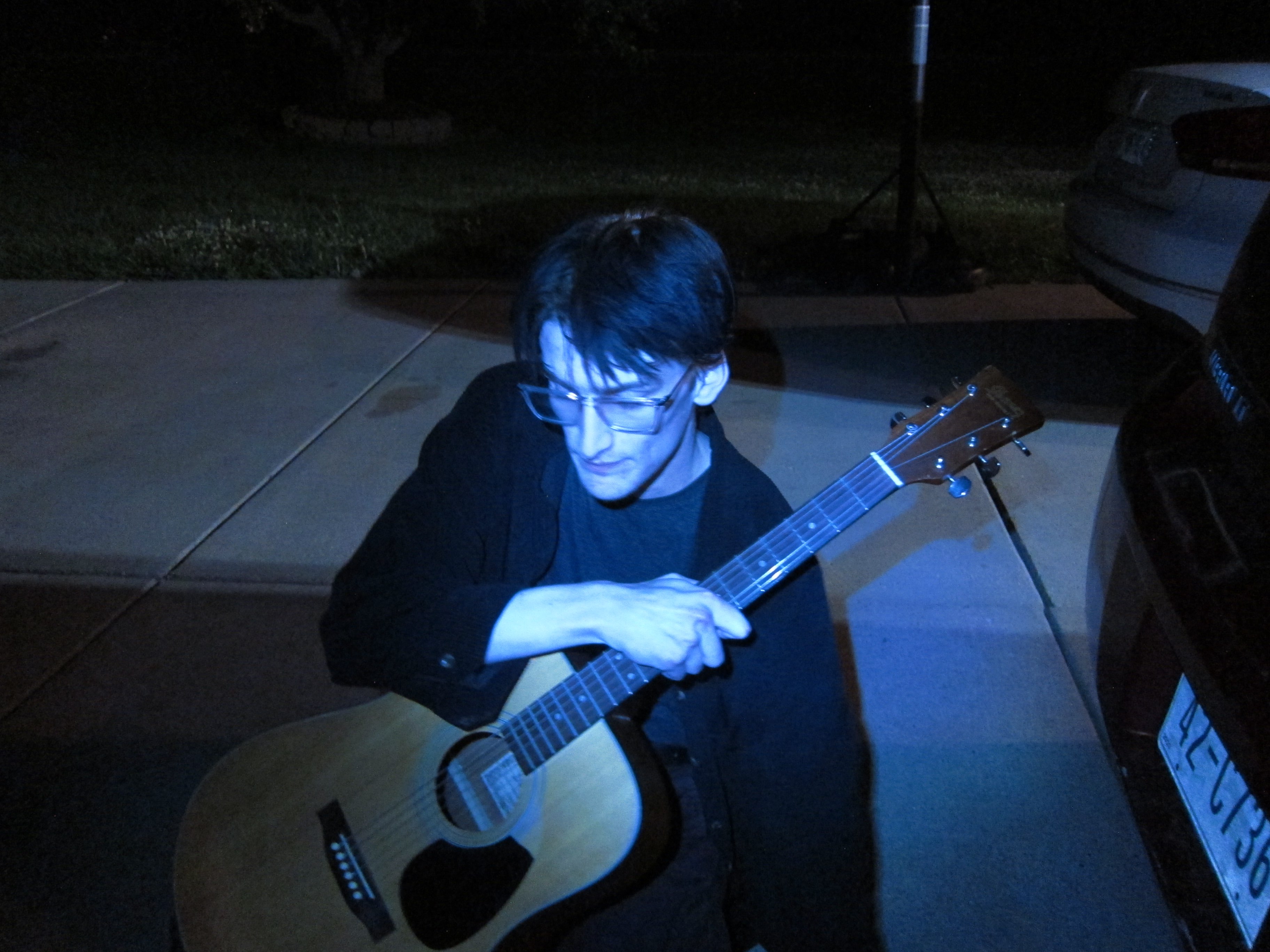 a man playing an acoustic guitar