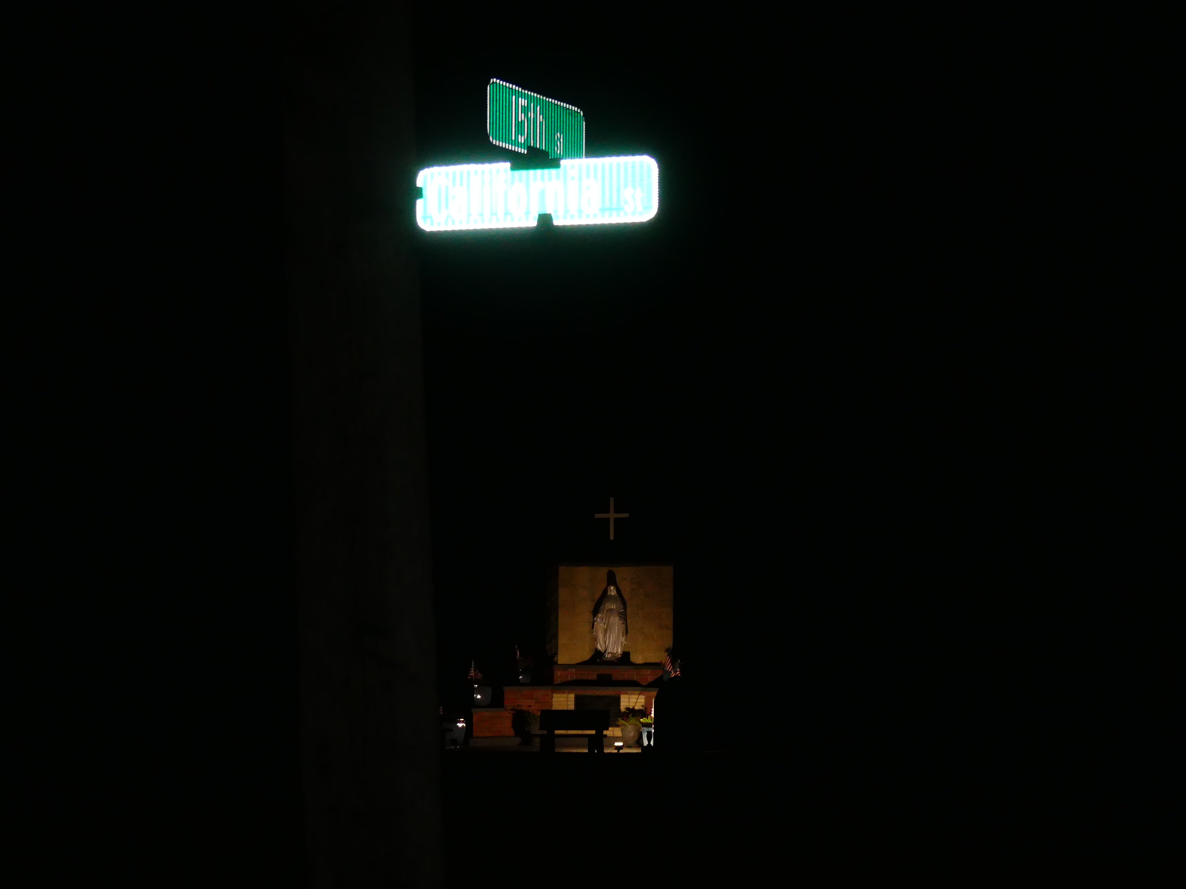 John California - St. California: a street sign on a pole at night