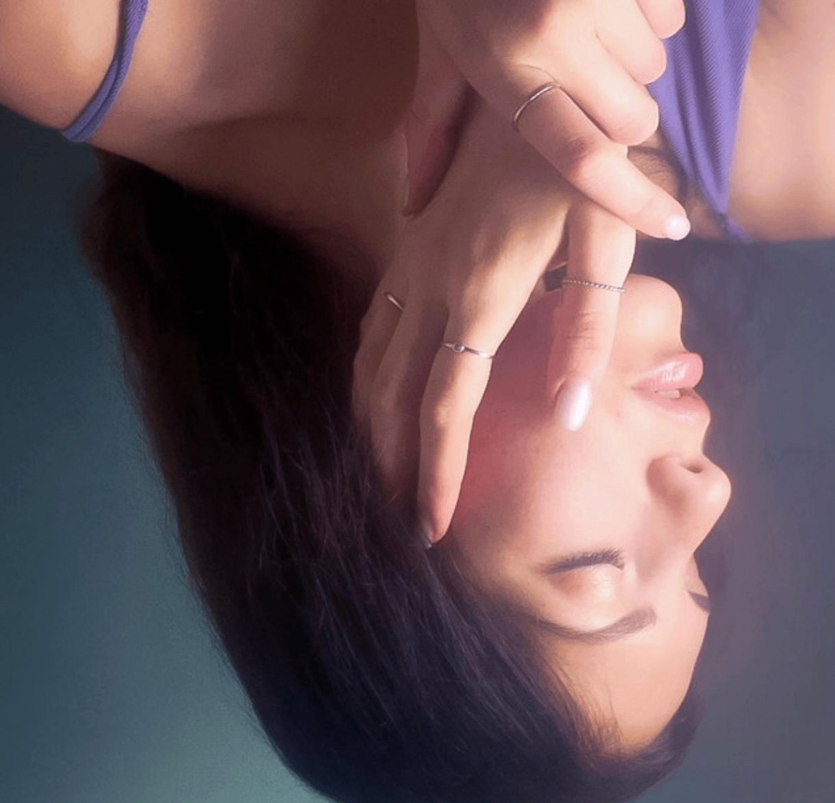 Katherine Cotter - Arm's Length: a woman laying down with her hands on her face
