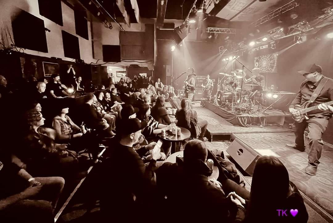 a group of people watching a band on stage