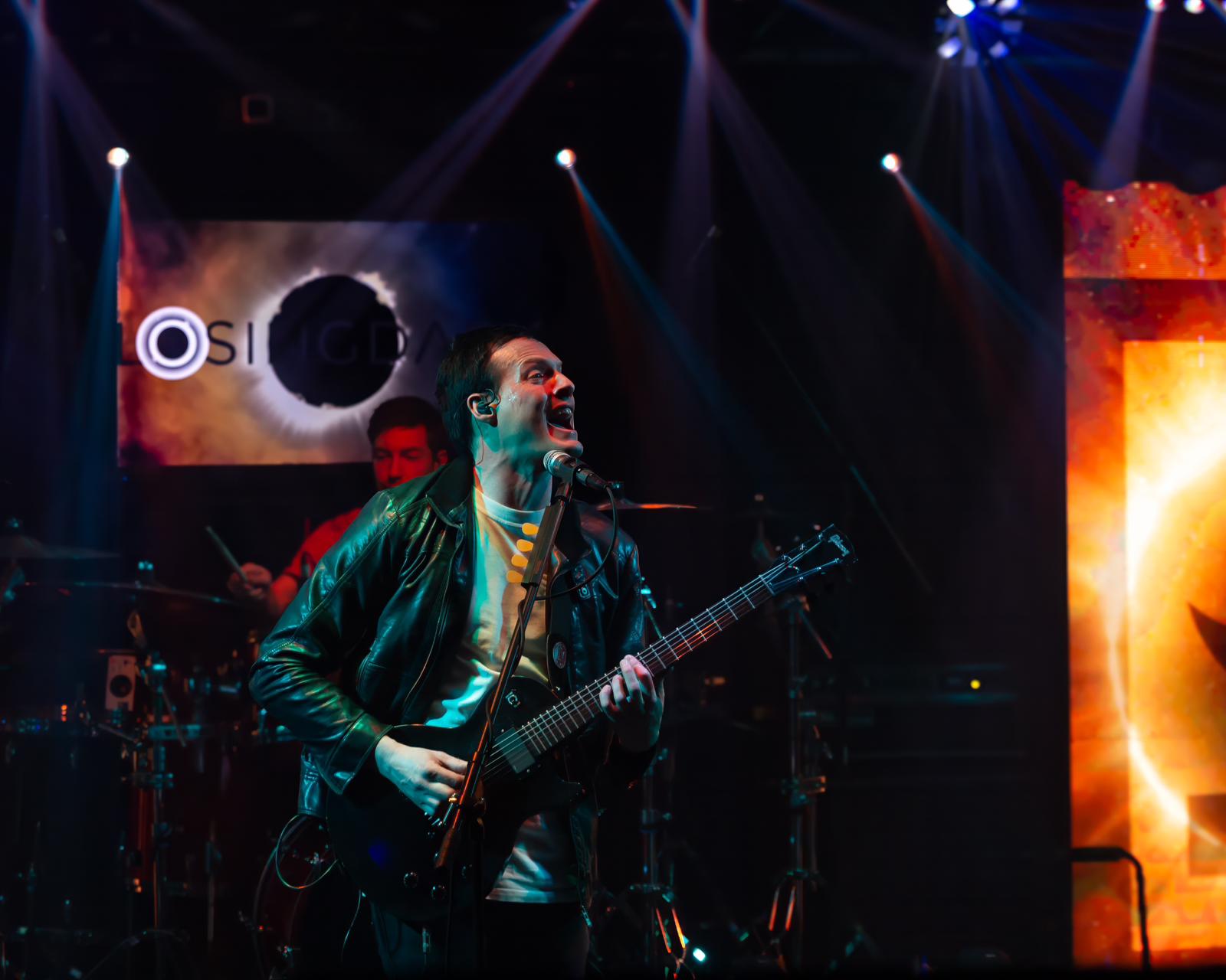 a man playing a guitar on stage