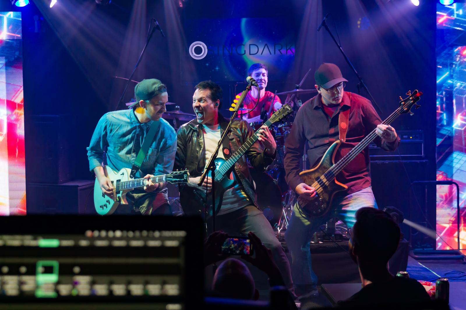 a group of musicians playing on stage at a concert