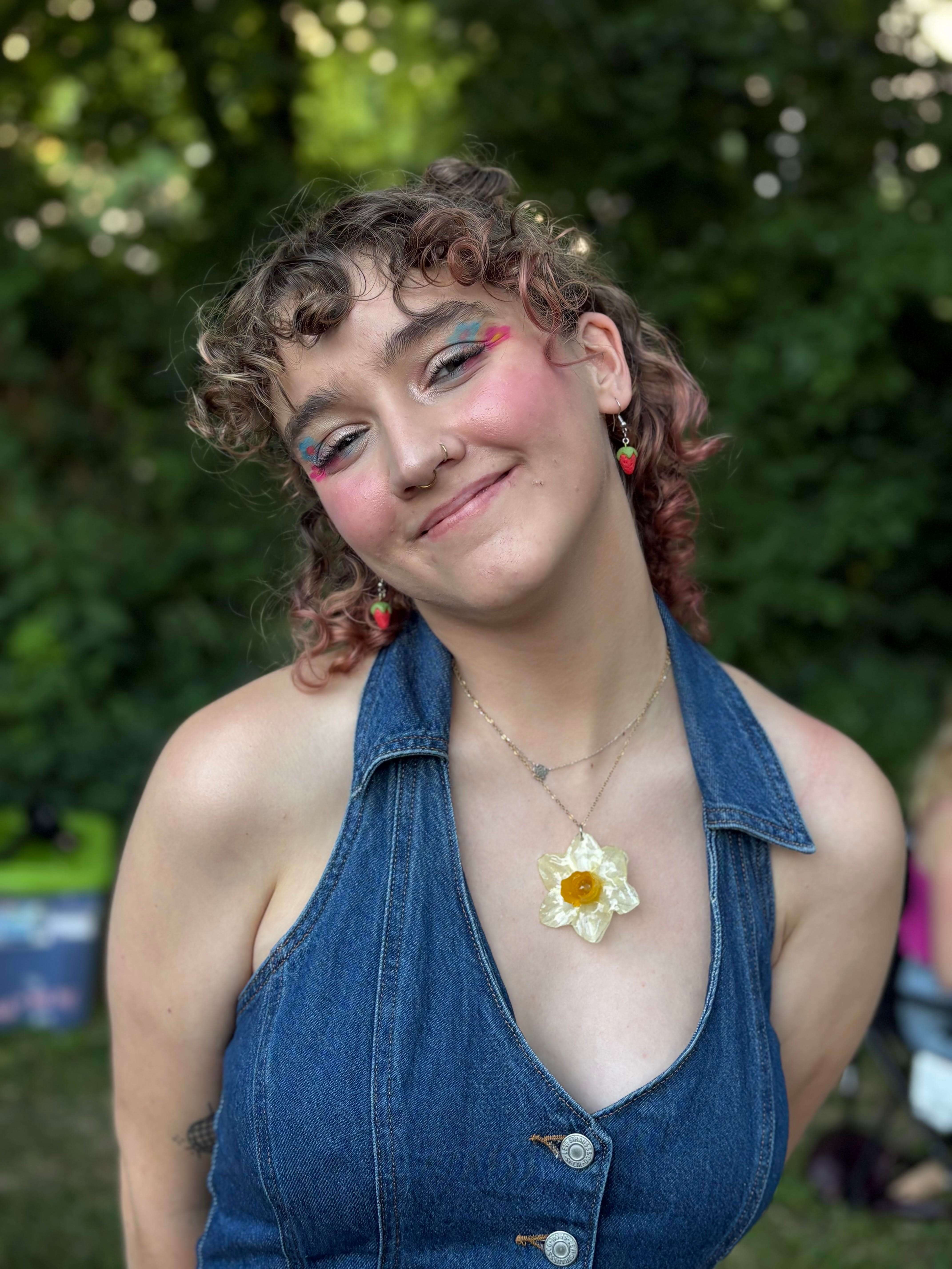a woman in a denim dress with a flower in her hair