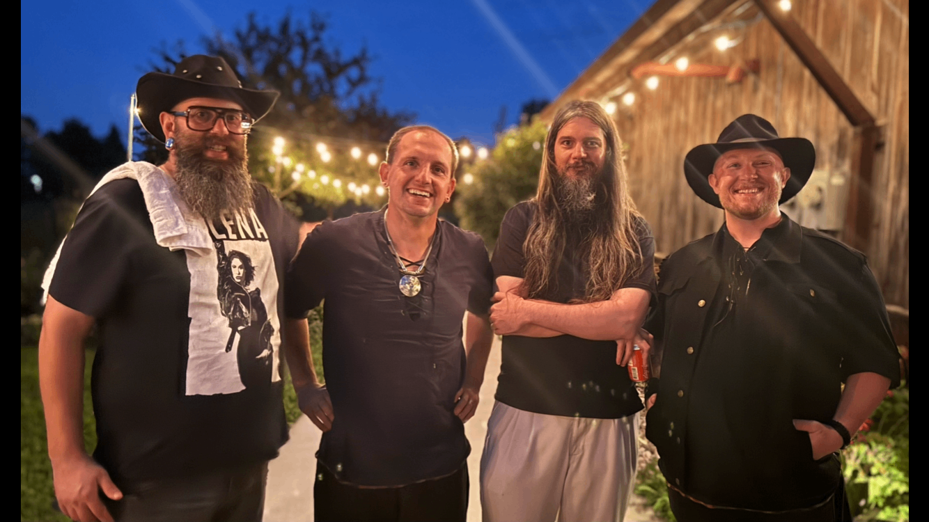 four men with beards and hats posing for a picture