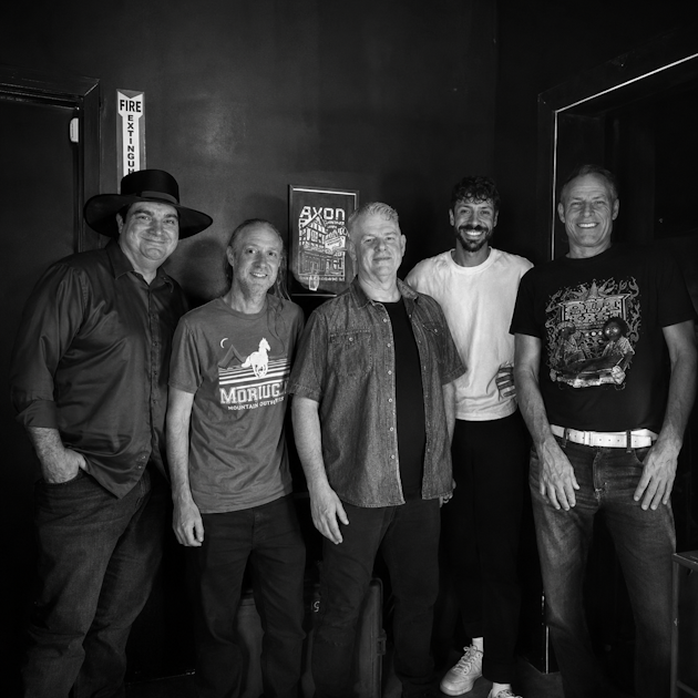 a group of men standing next to each other in a black and white photo