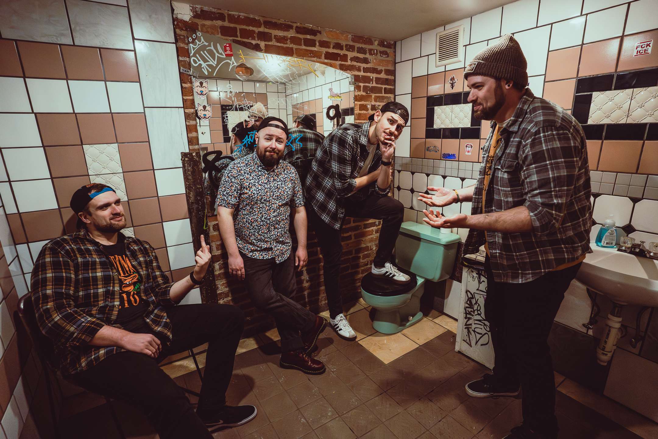 a group of men standing in a bathroom