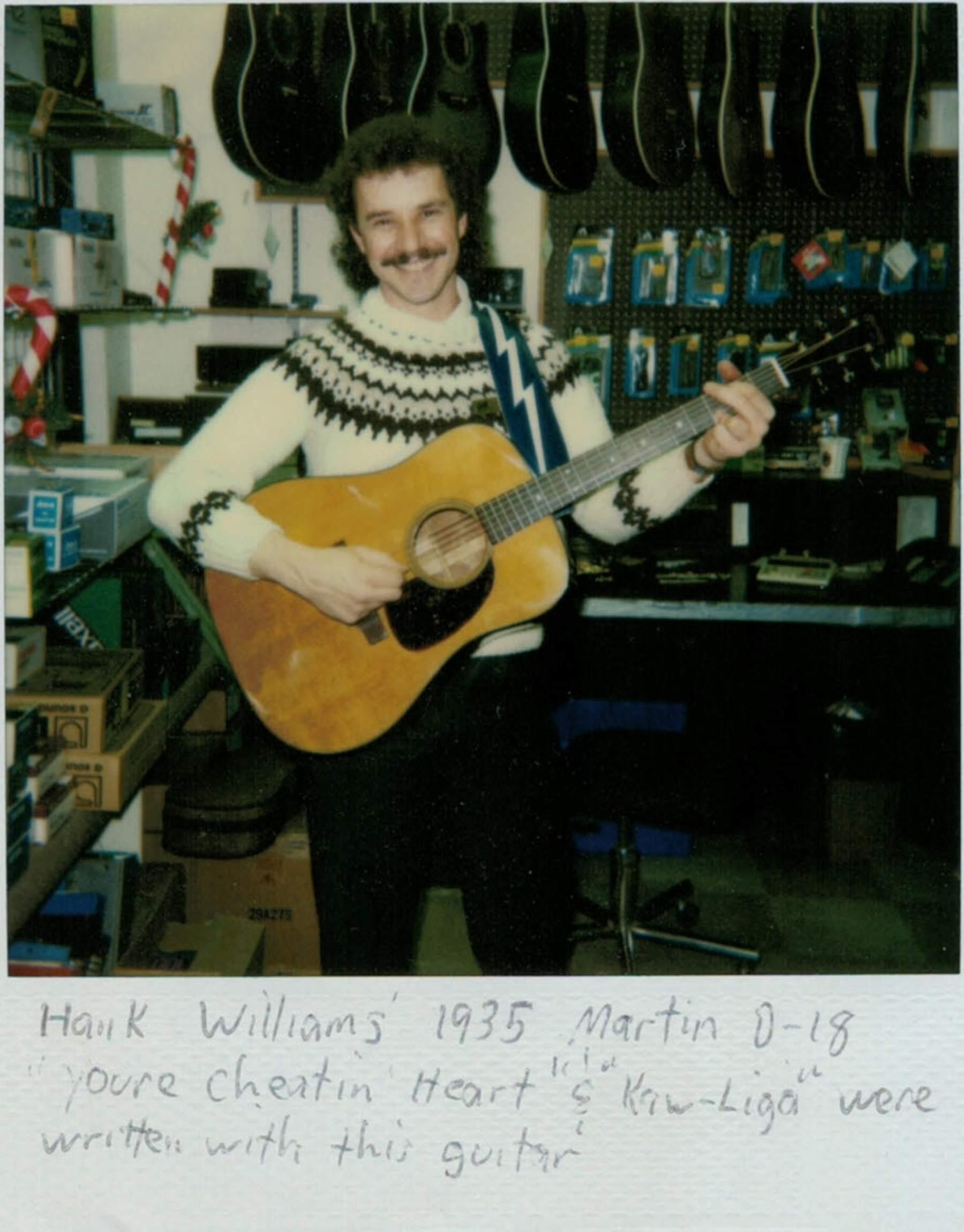 a man holding an acoustic guitar