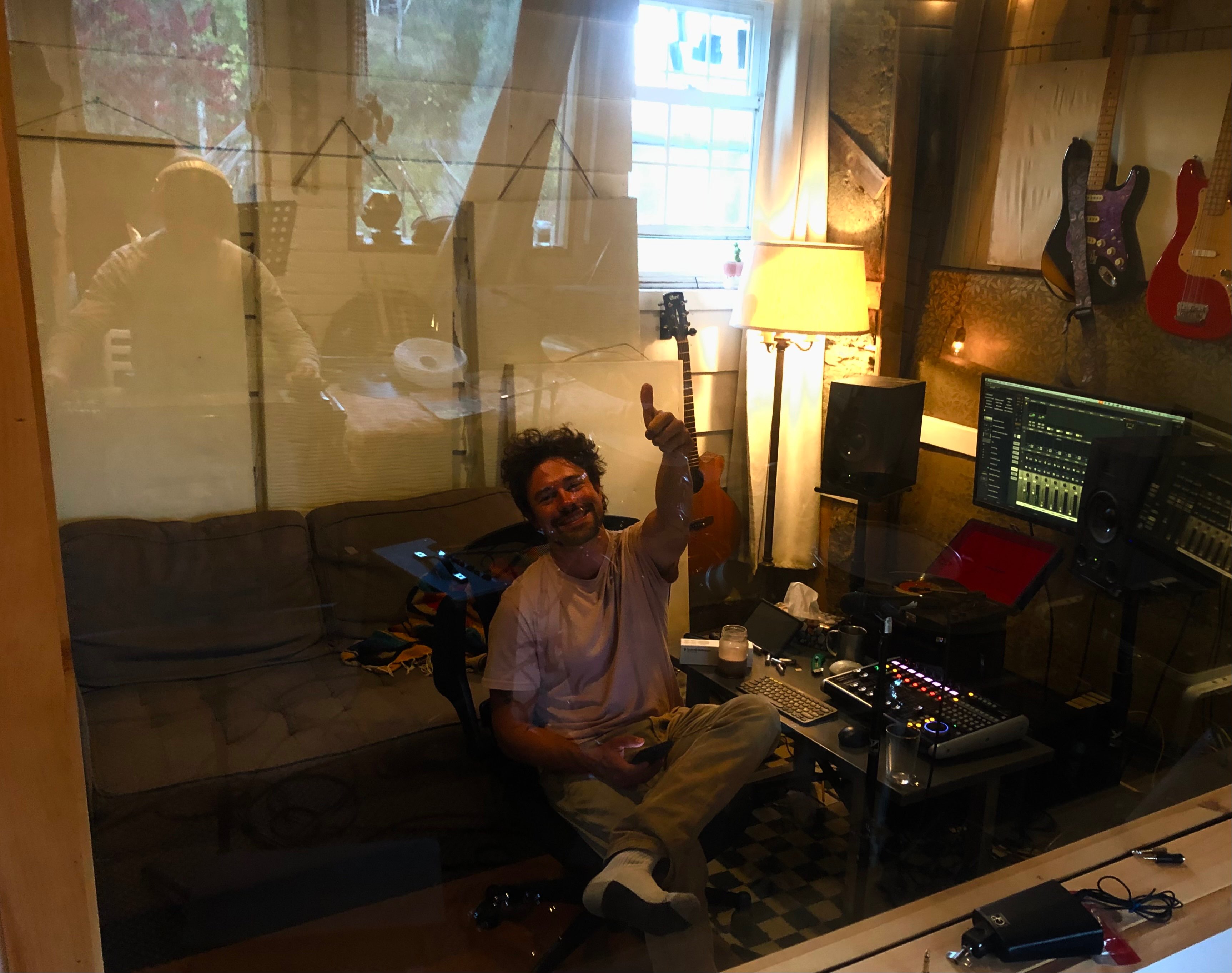 a man is sitting in a recording studio