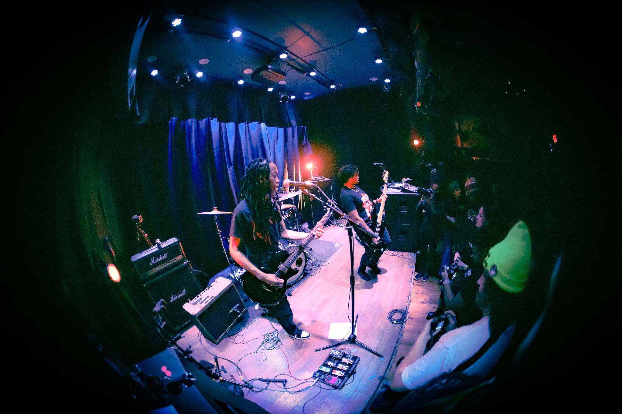 a group of people playing a musical instrument in a dark room