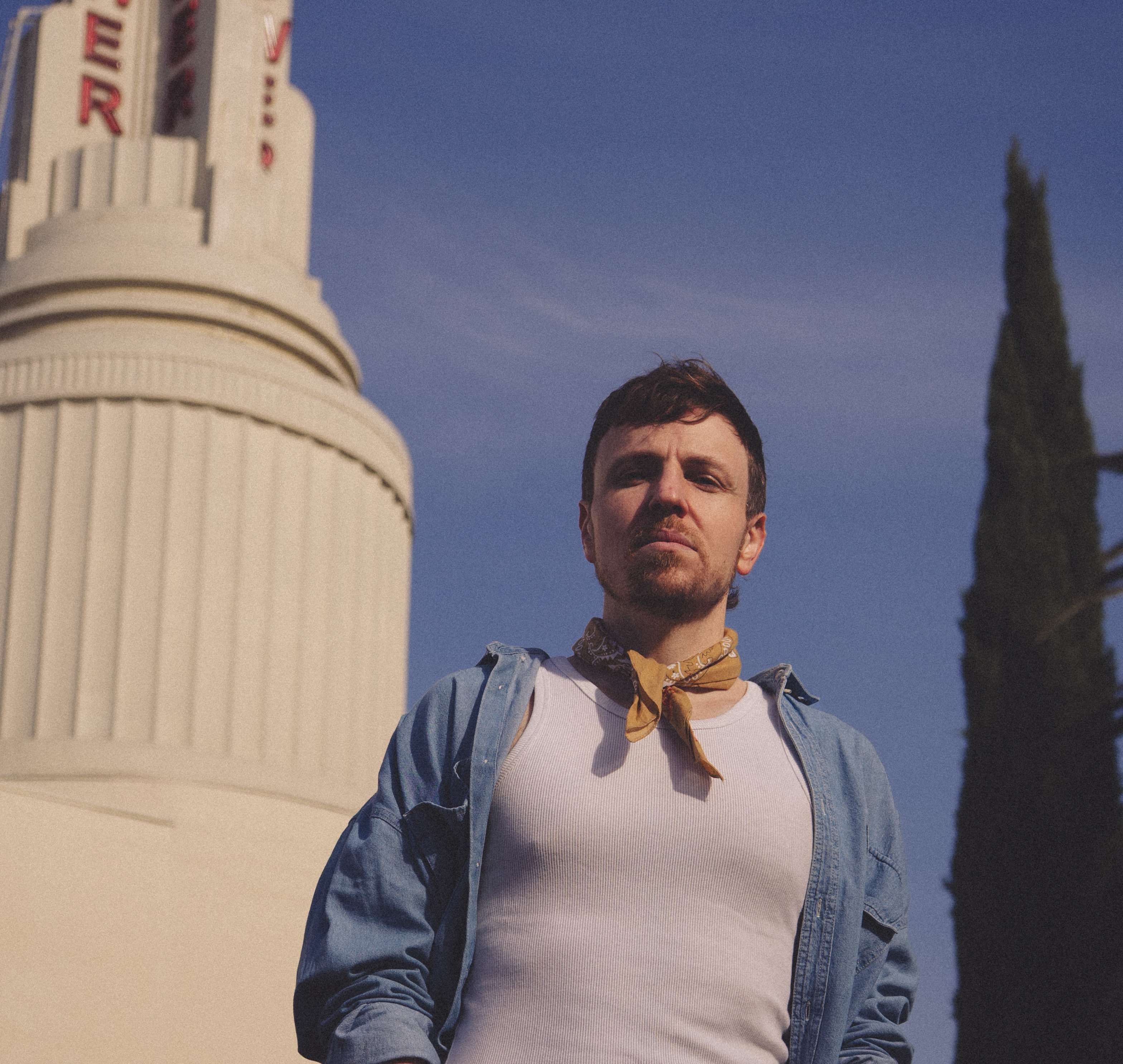 a man is standing in front of a building