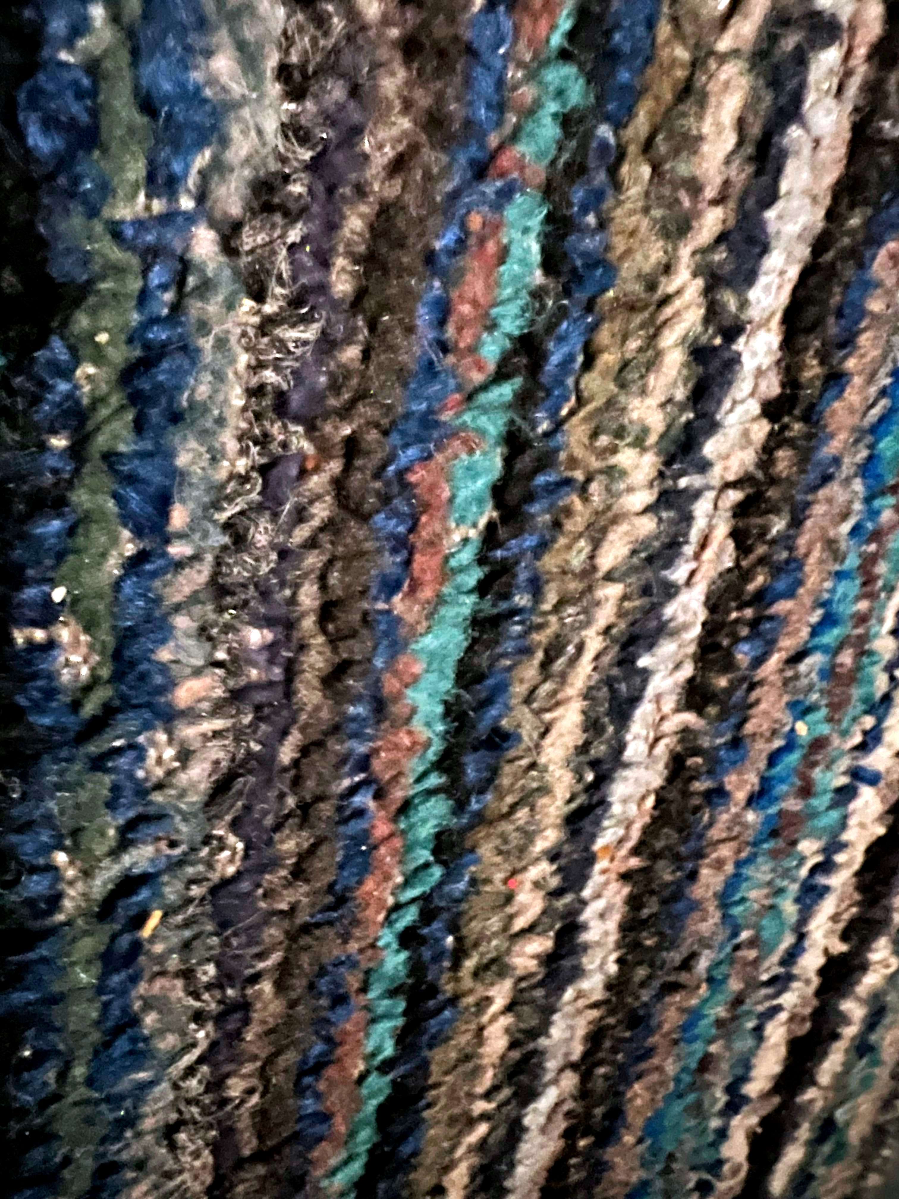 A Verge Called Krell tip jar: a close up of a blue and black rug