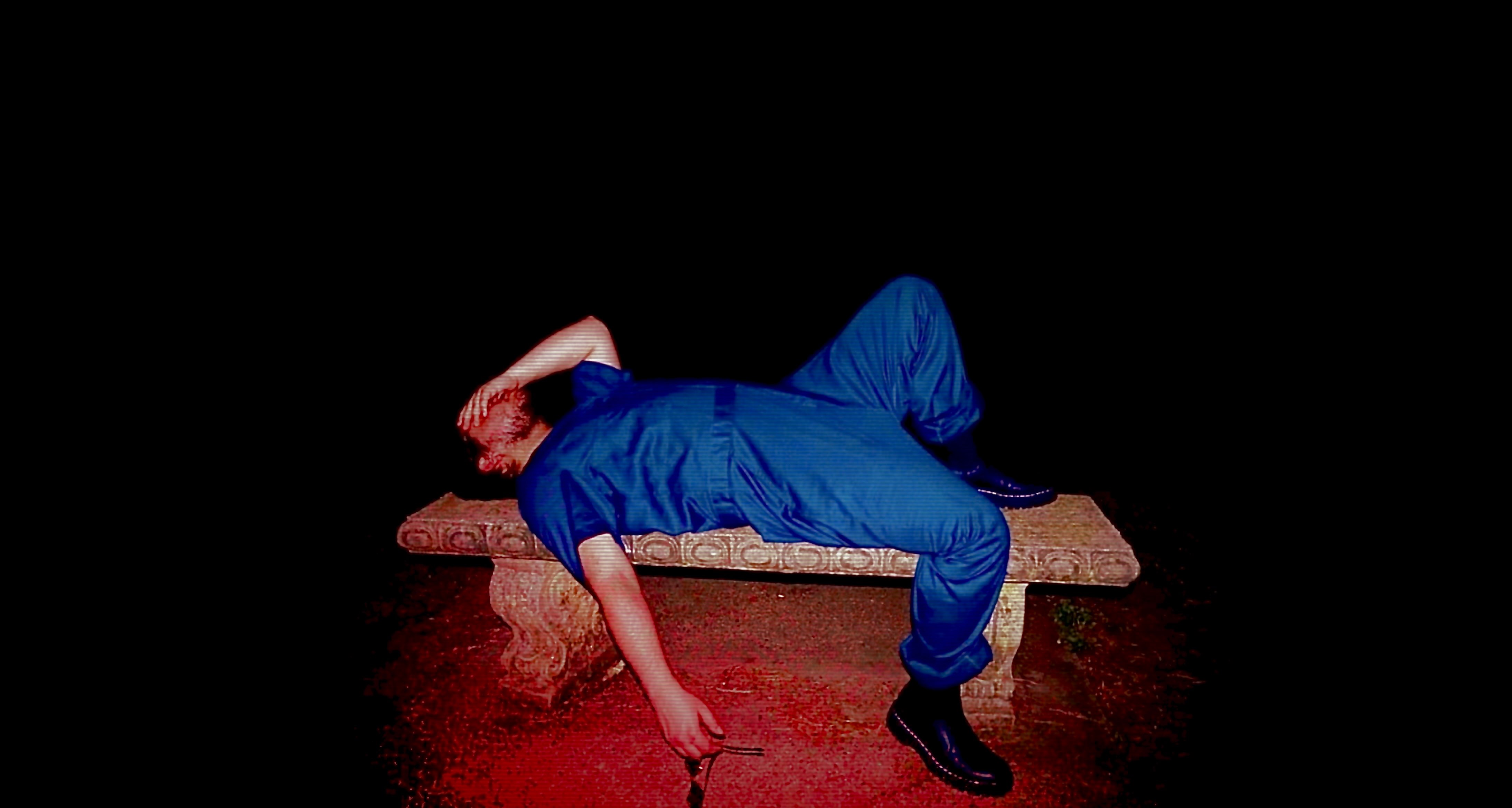 a man laying on a bench