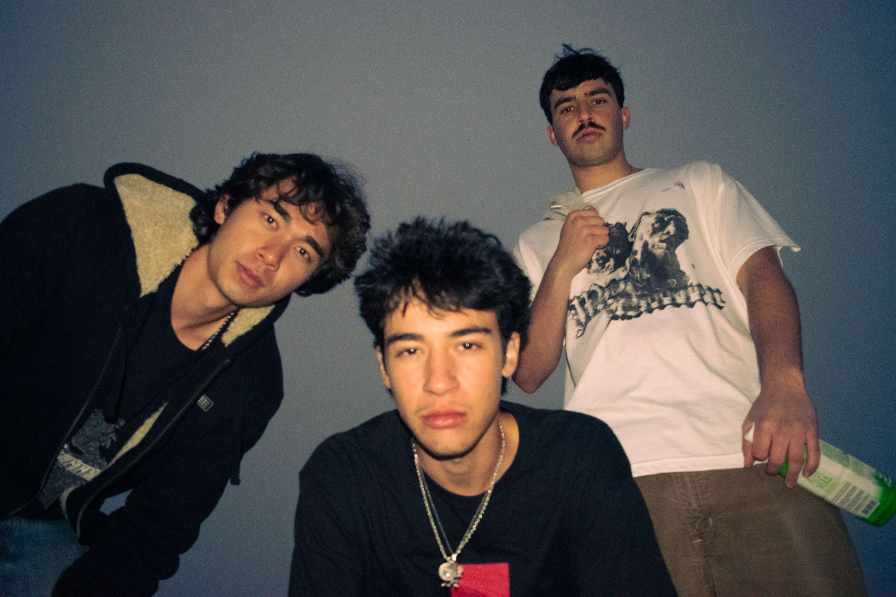 three young men standing next to each other