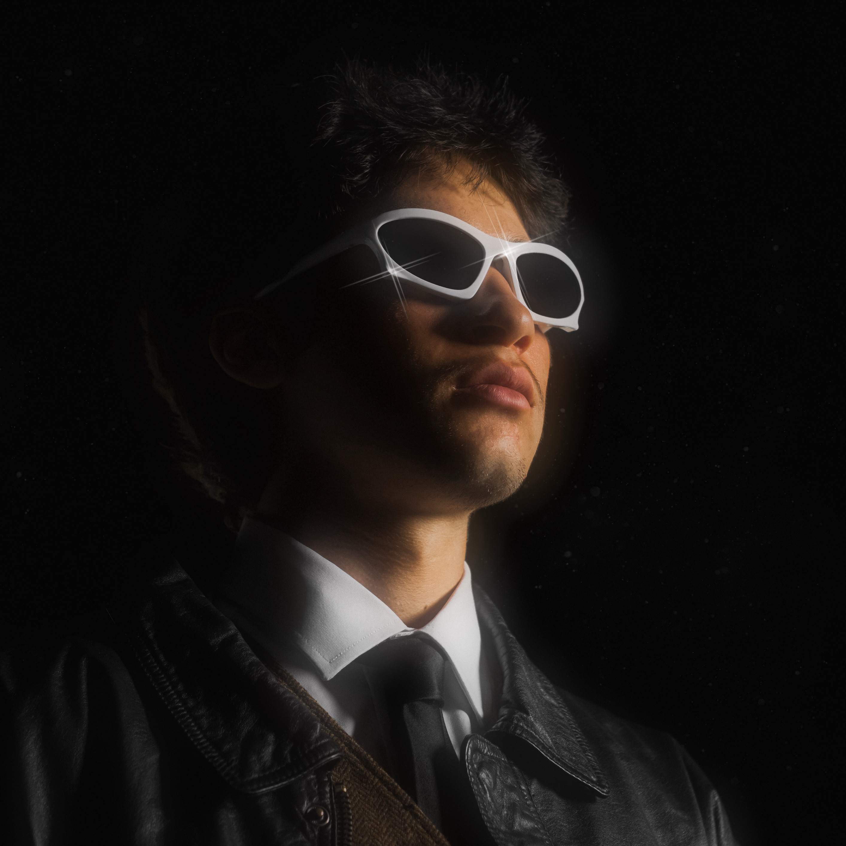 Meer Mutter - BIRDS DON'T FLY AT NIGHT - ZAYD: a man in a suit and tie wearing sunglasses