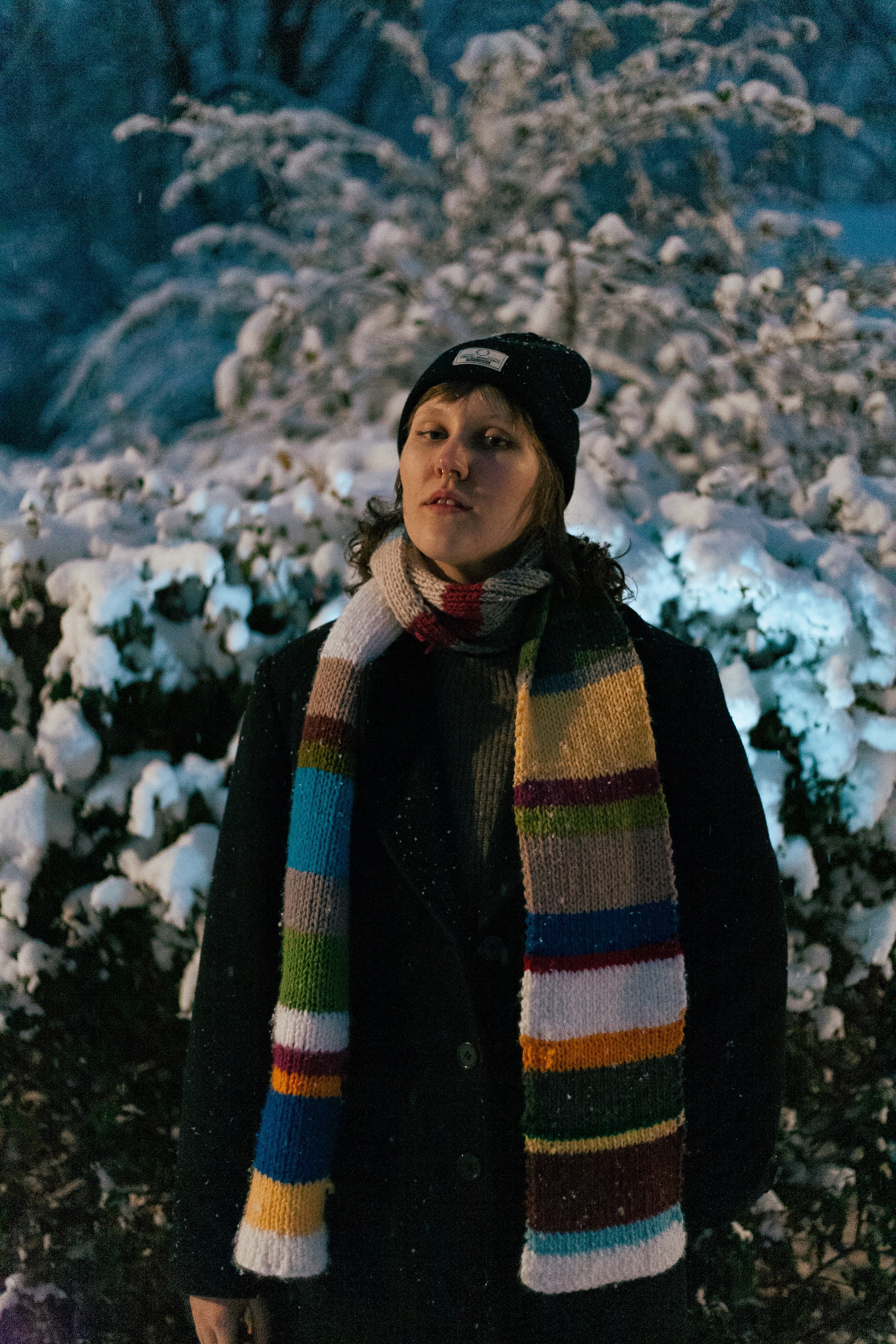 a woman wearing a colorful scarf in the snow