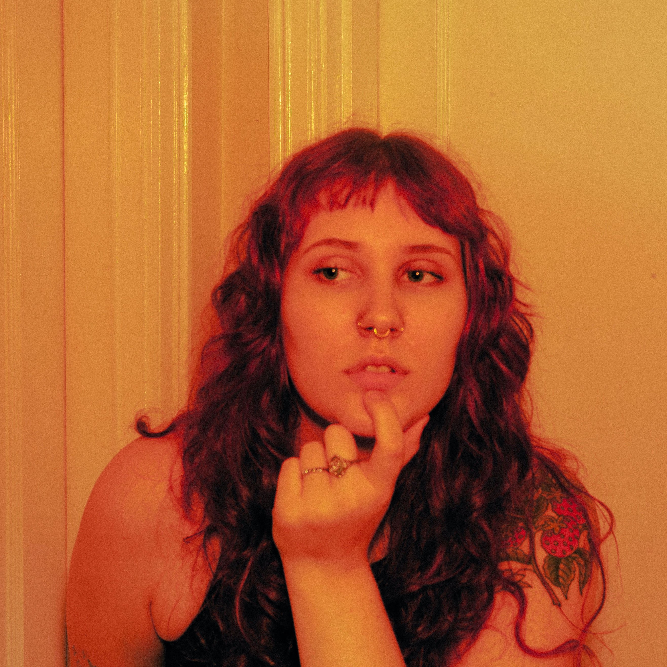 a woman with red hair is posing for a picture