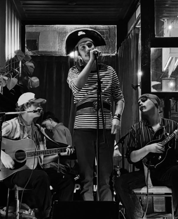 a black and white photo of a group of people playing music