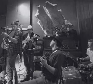 a group of people playing music in a bar