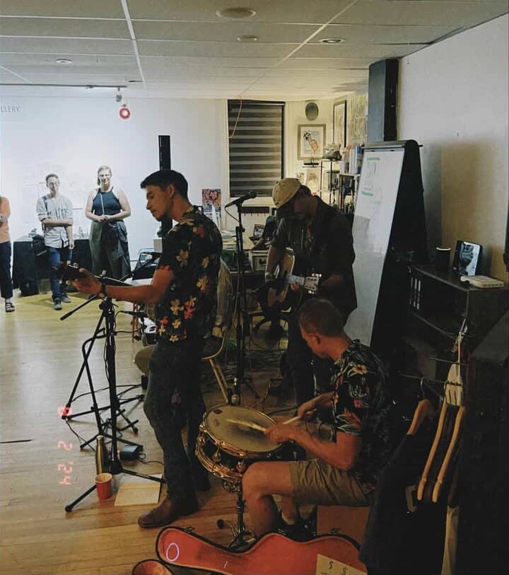a group of people playing music in a room