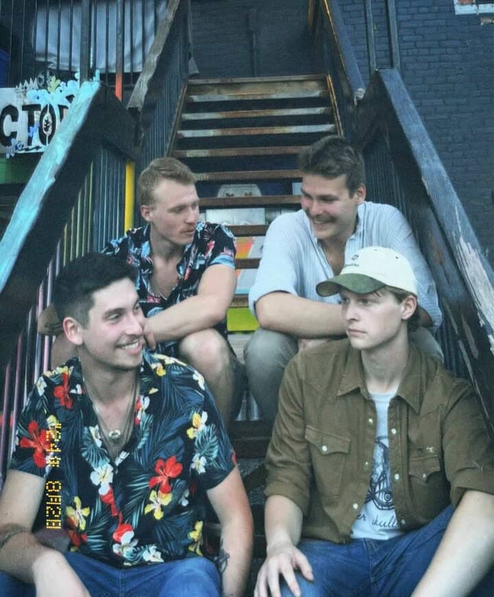 a group of young men sitting on a set of stairs