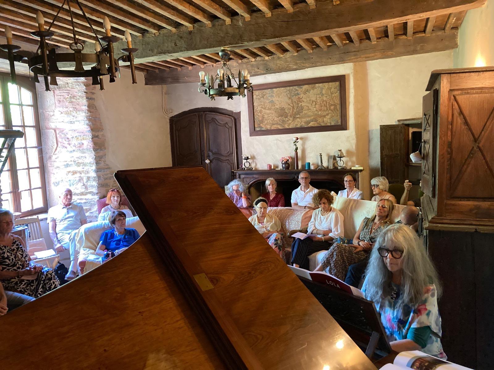 a group of people sitting around a piano