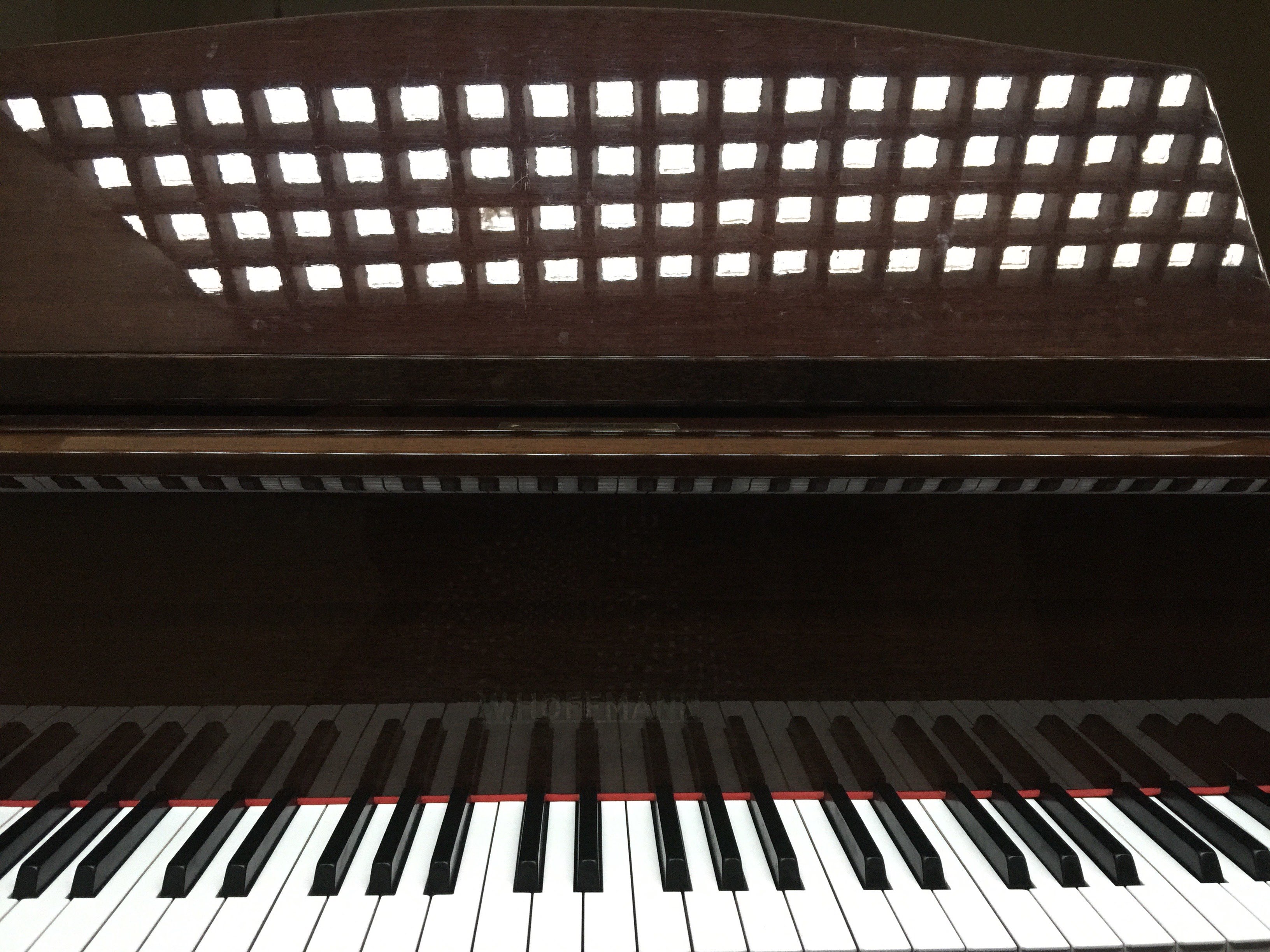 a close up of a piano with a black and white checkered pattern