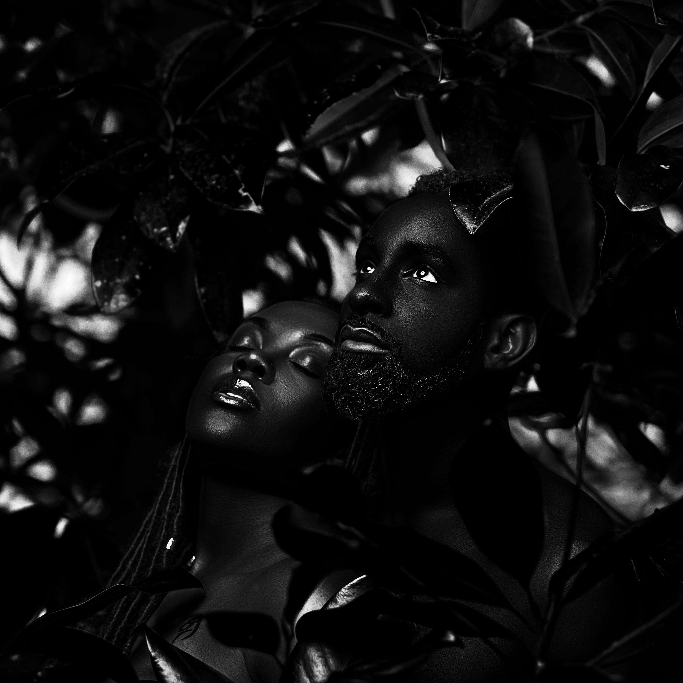 Revilo_X - Jah Blessed Us: a black and white photo of a couple in the forest