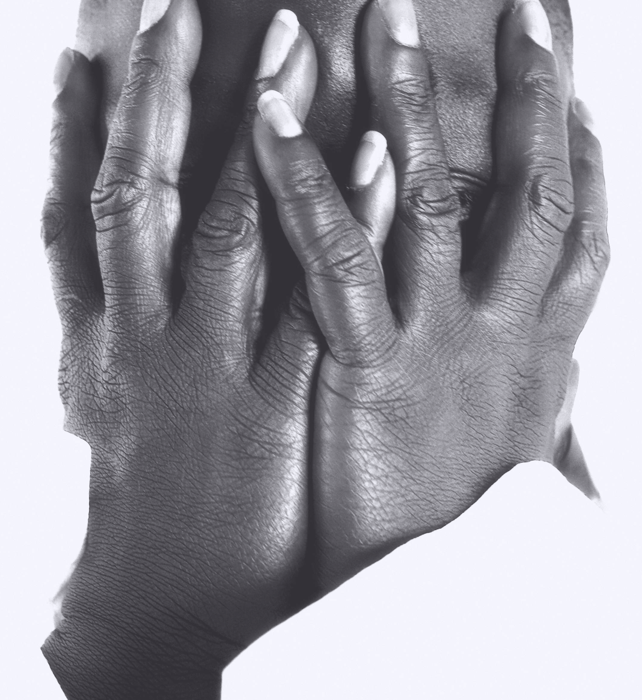 a black and white photo of a man with his hands covering his face