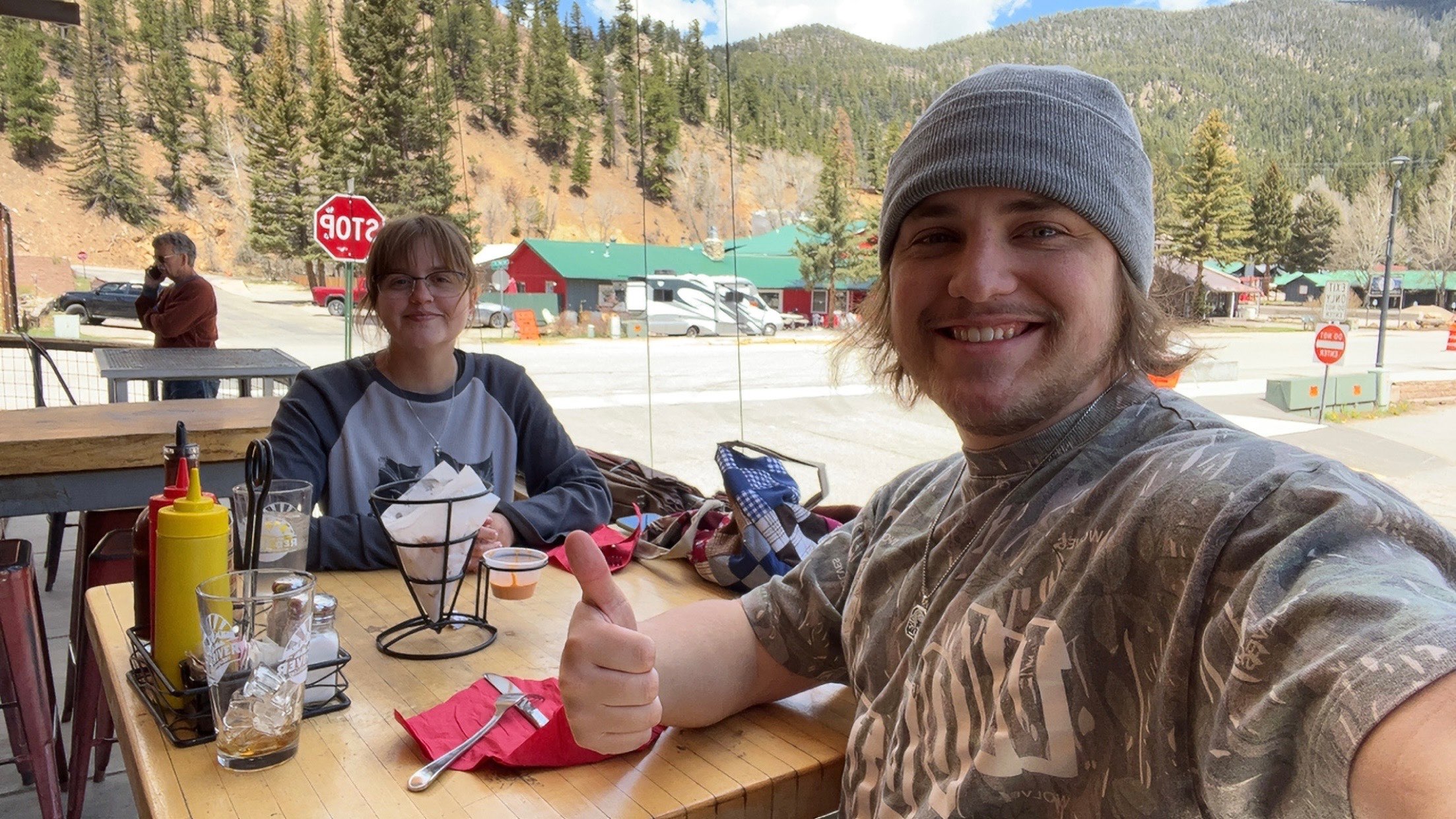 a man and woman taking a selfie at a restaurant