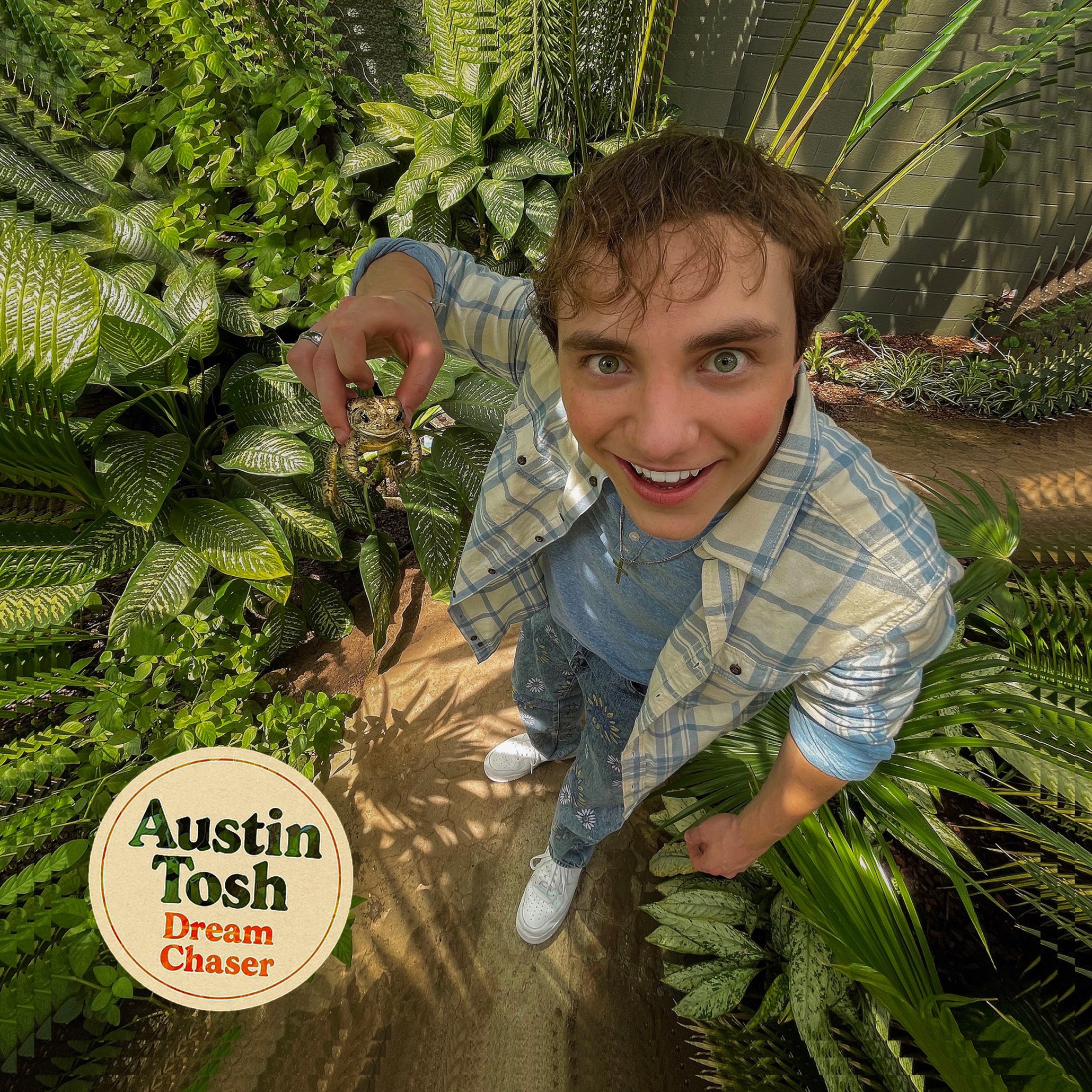 Austin Tosh - Dream Chaser: a man holding a plant in his hands