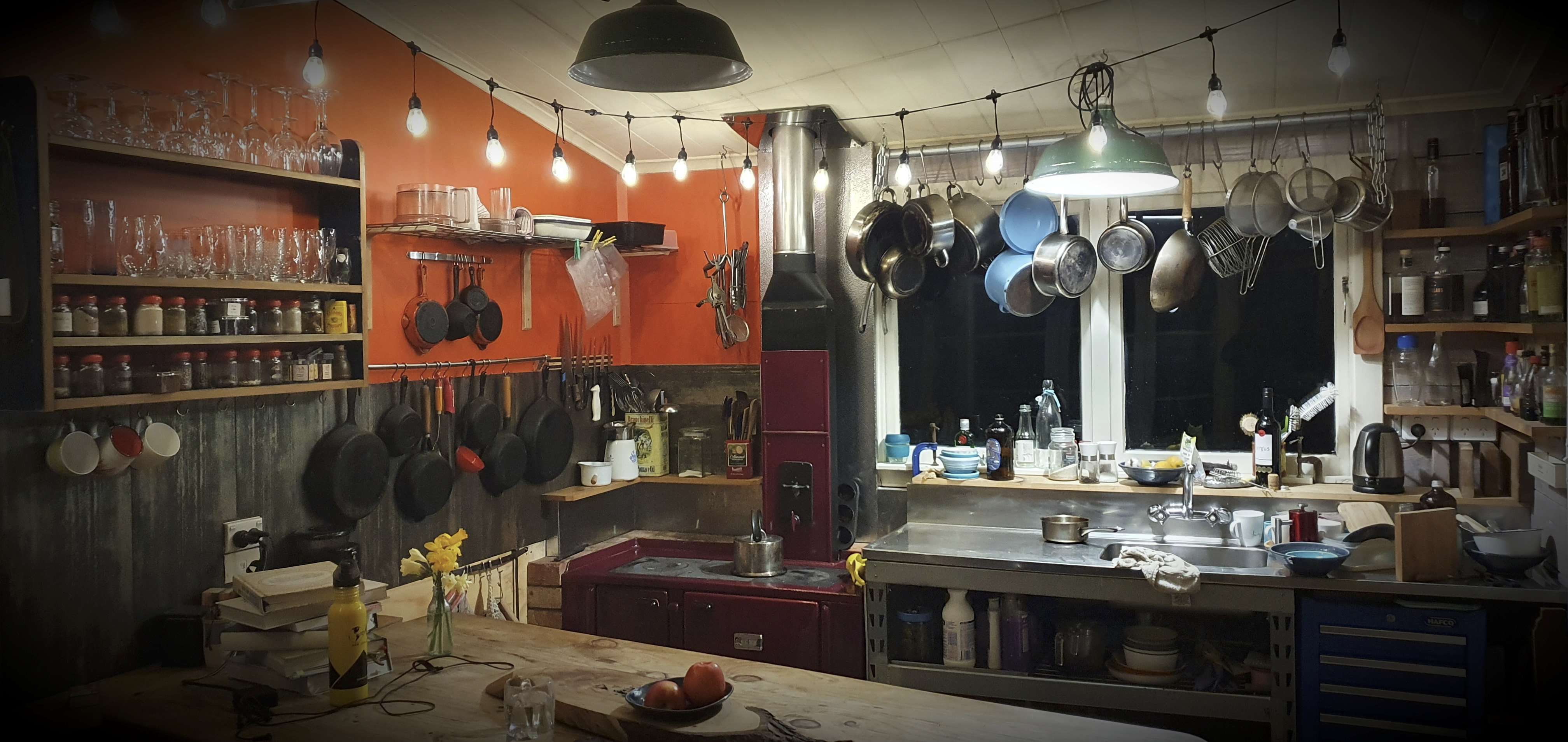 a kitchen with pots and pans hanging from the ceiling