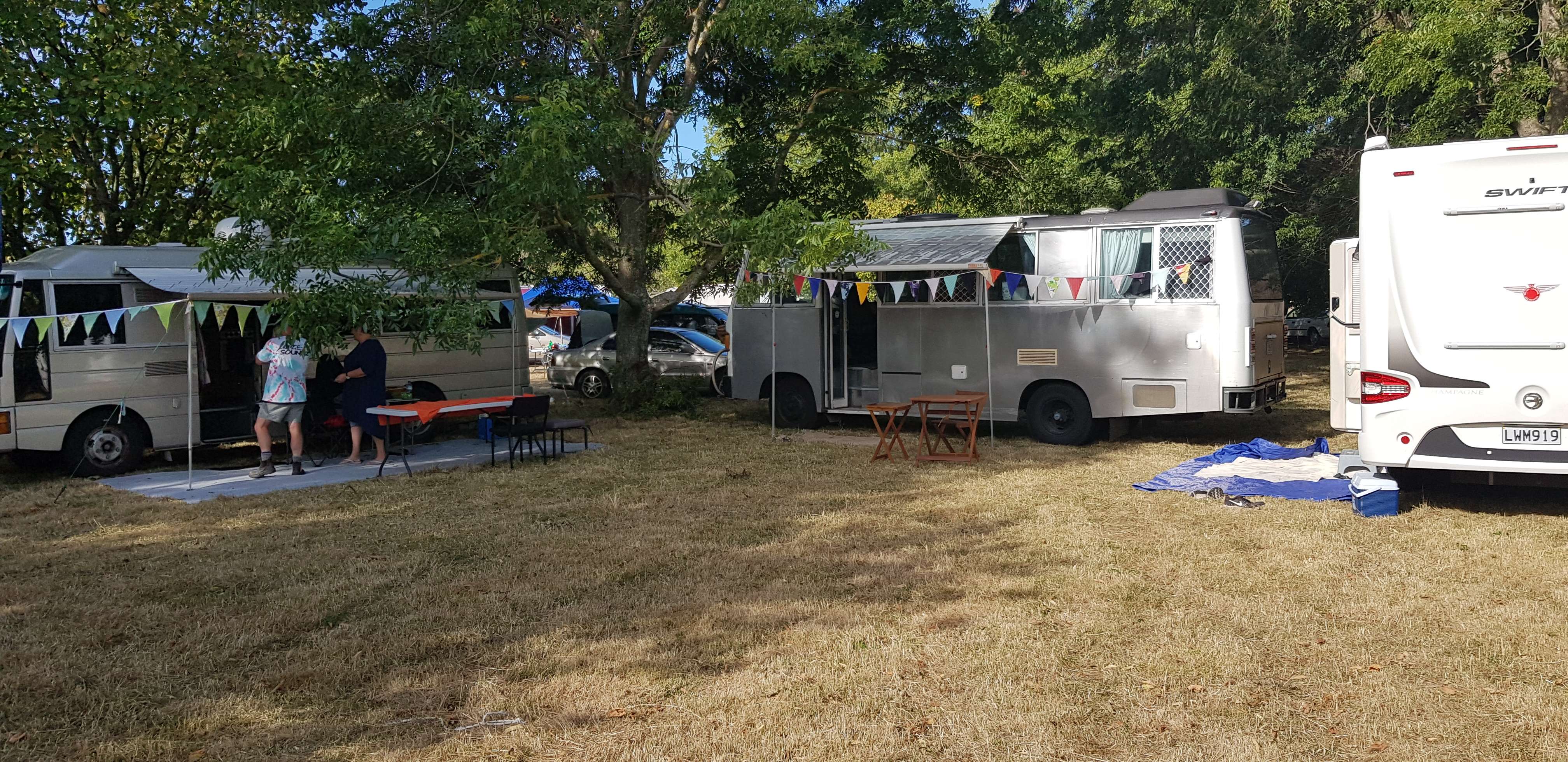 a group of rvs parked in a field