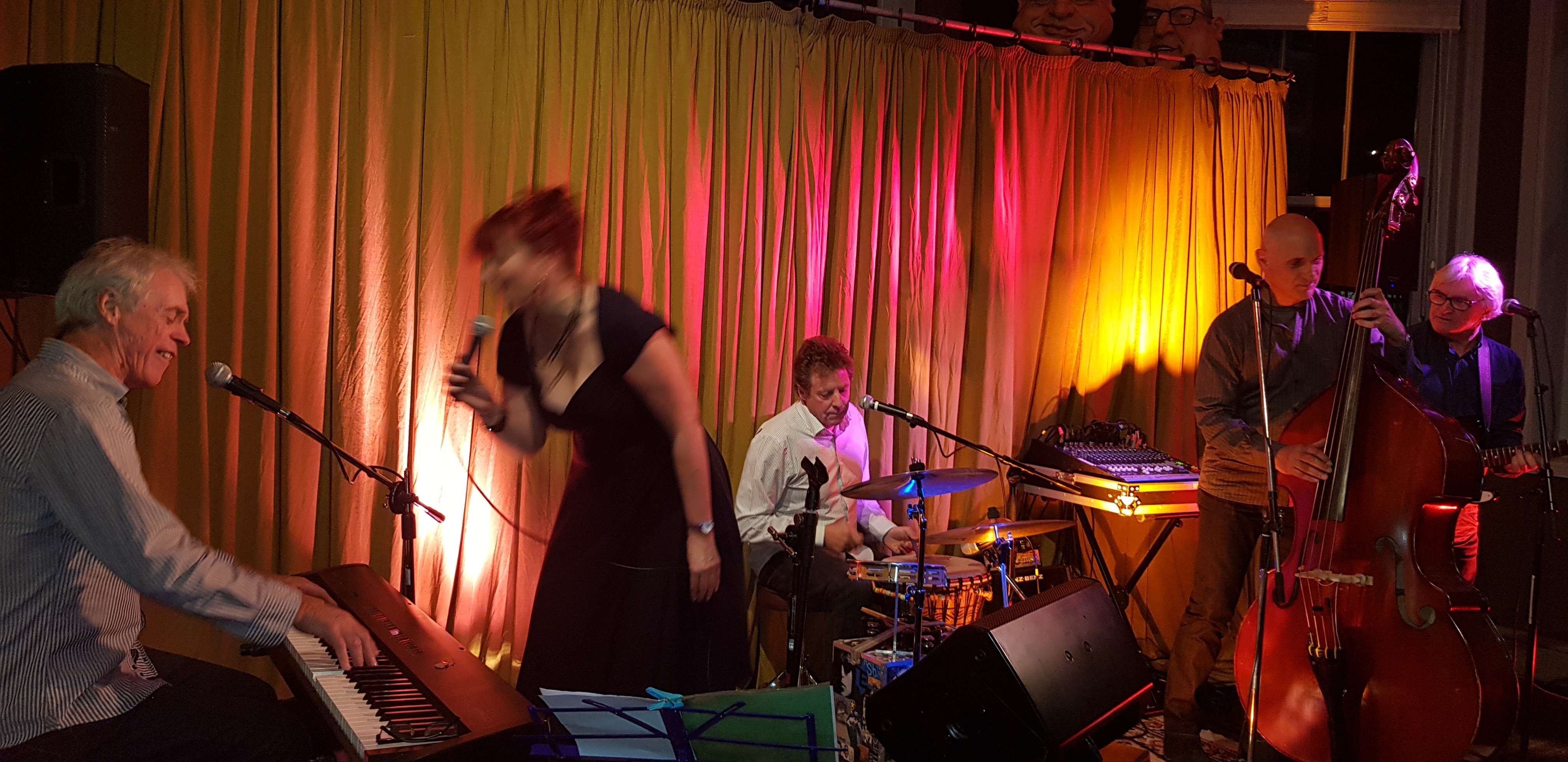 a group of people playing music on a stage