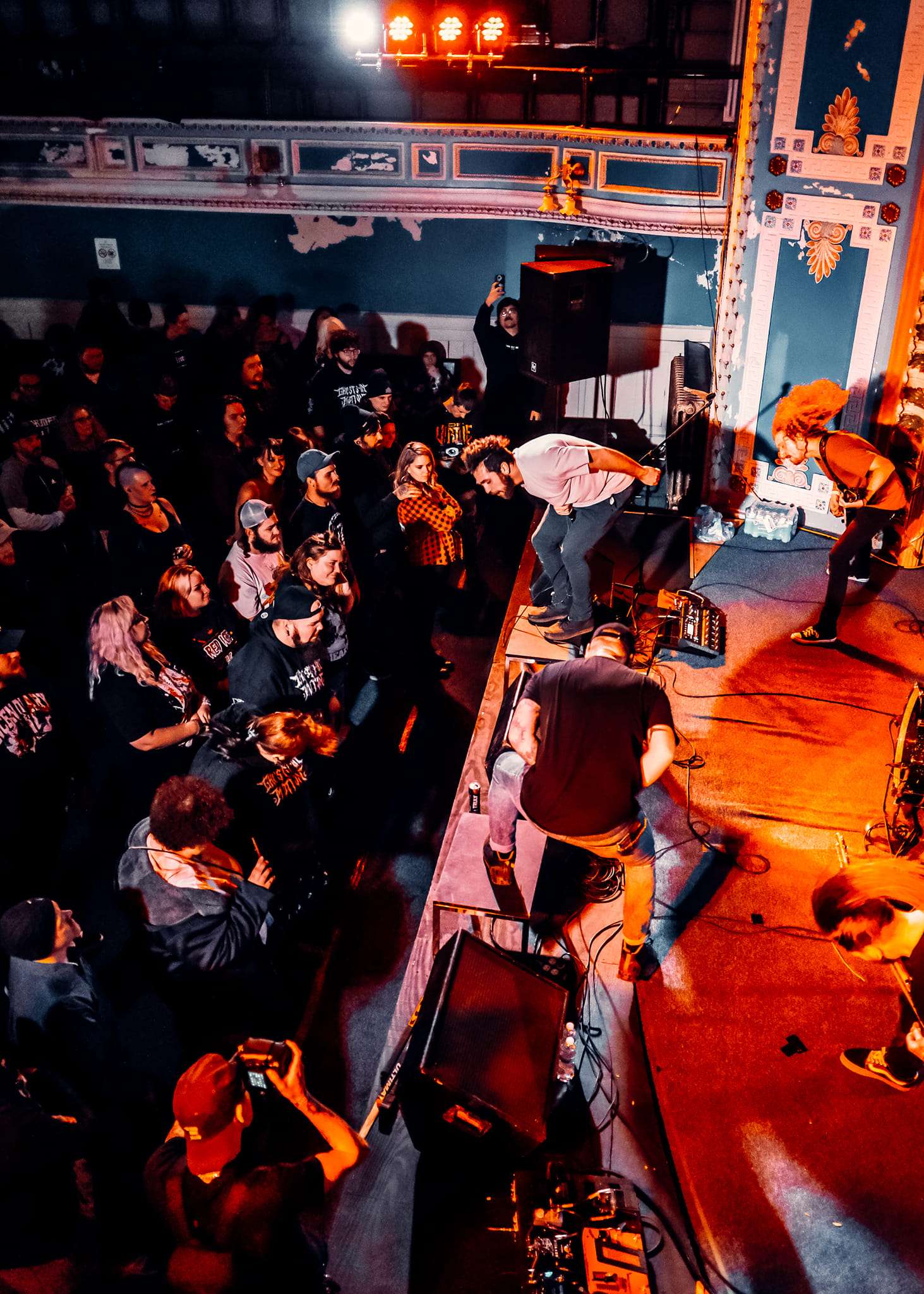 a group of people watching a band on stage