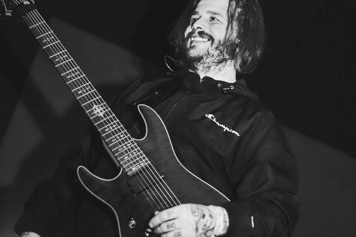 a black and white photo of a man playing an electric guitar