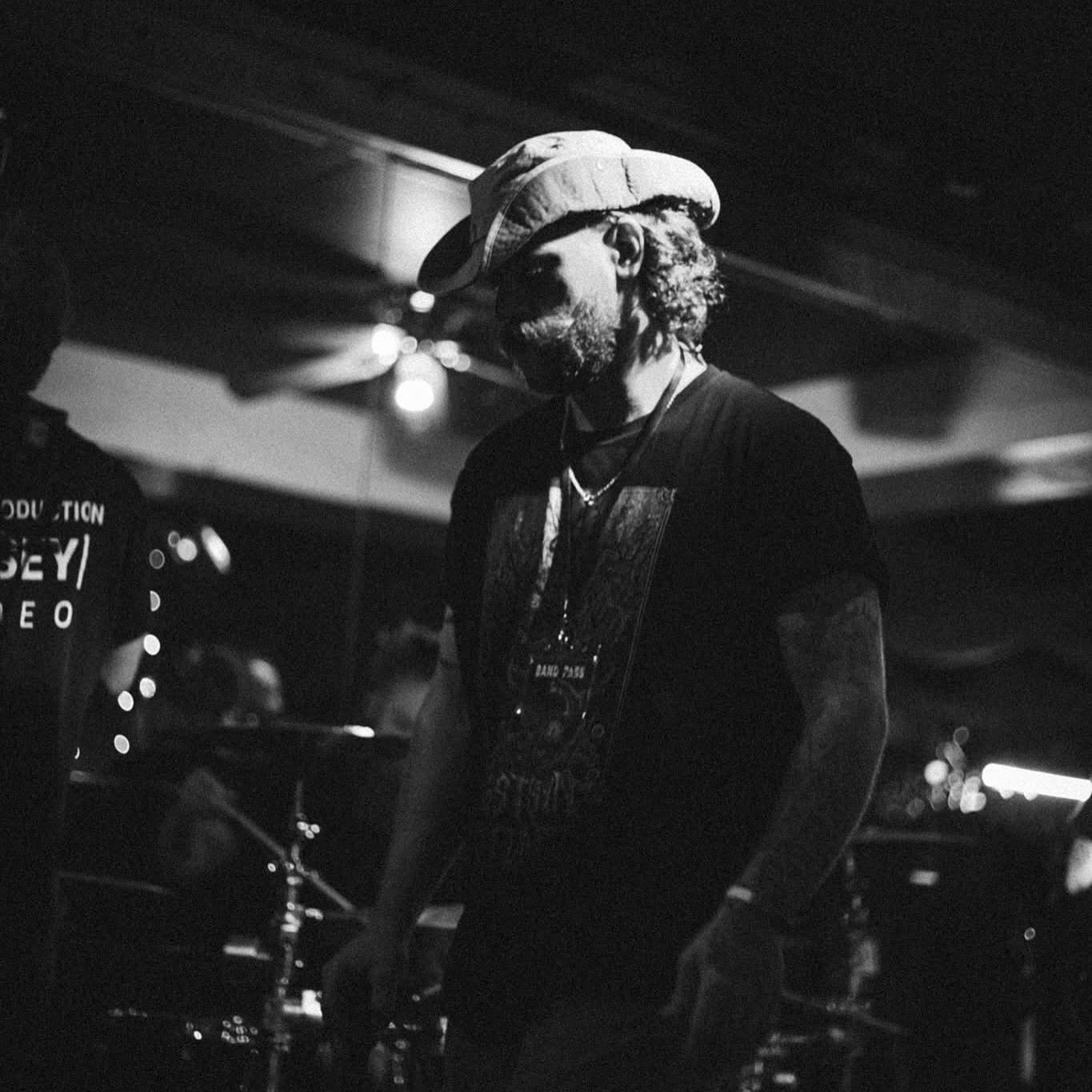 a man in a cowboy hat standing in a band