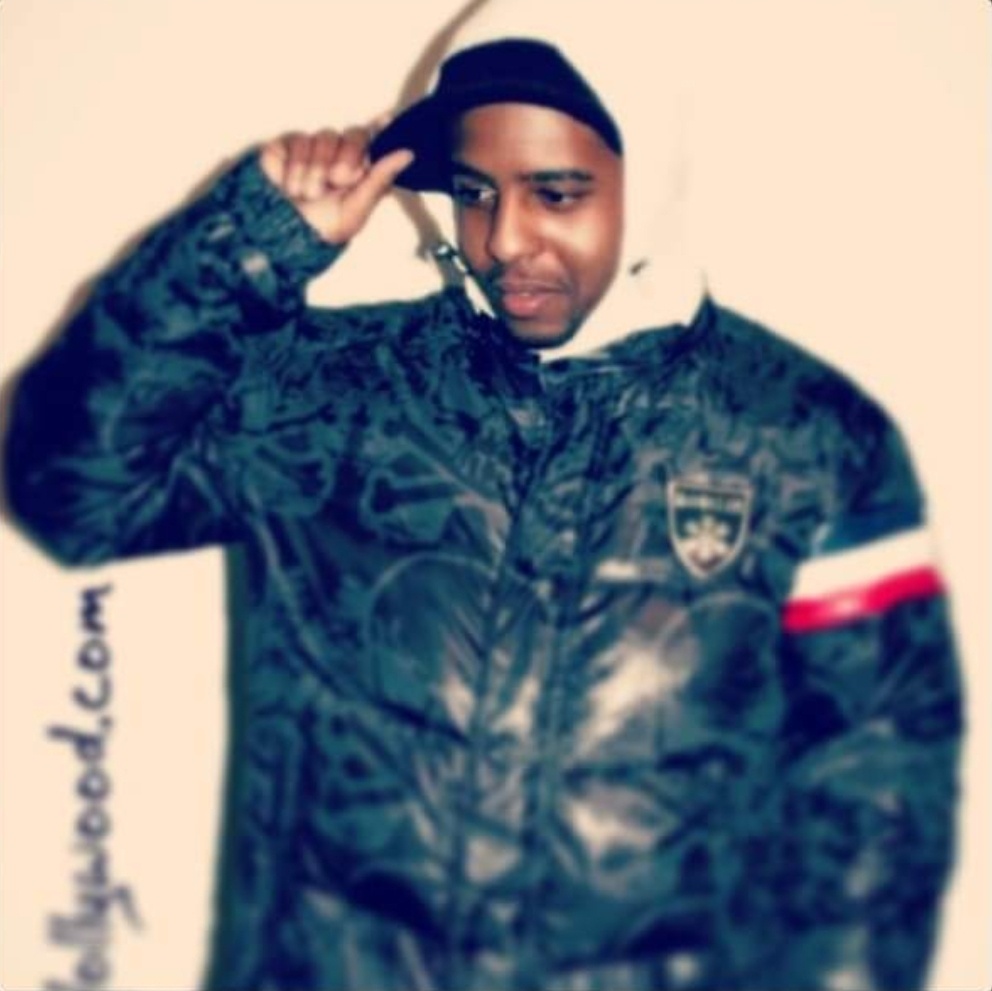 a man in a black jacket posing for a picture