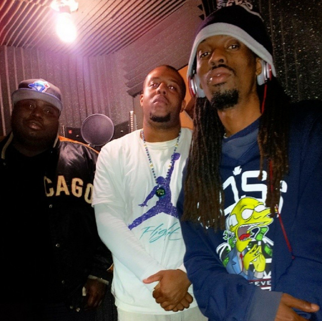 three men with dreadlocks standing in a recording studio