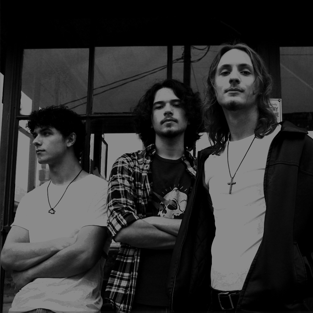 a group of young men standing in front of a store