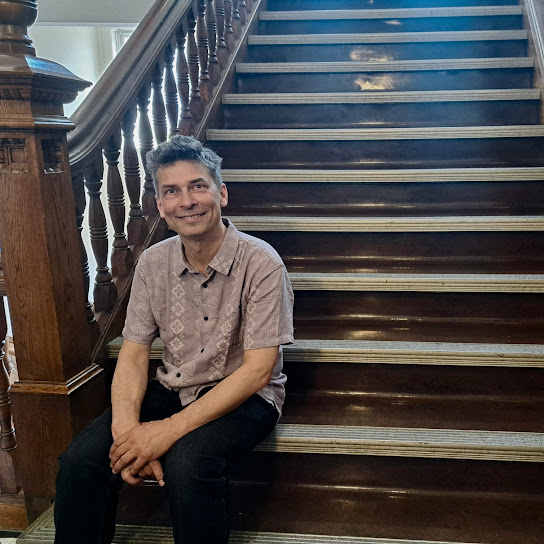 a man sitting on the stairs of a building