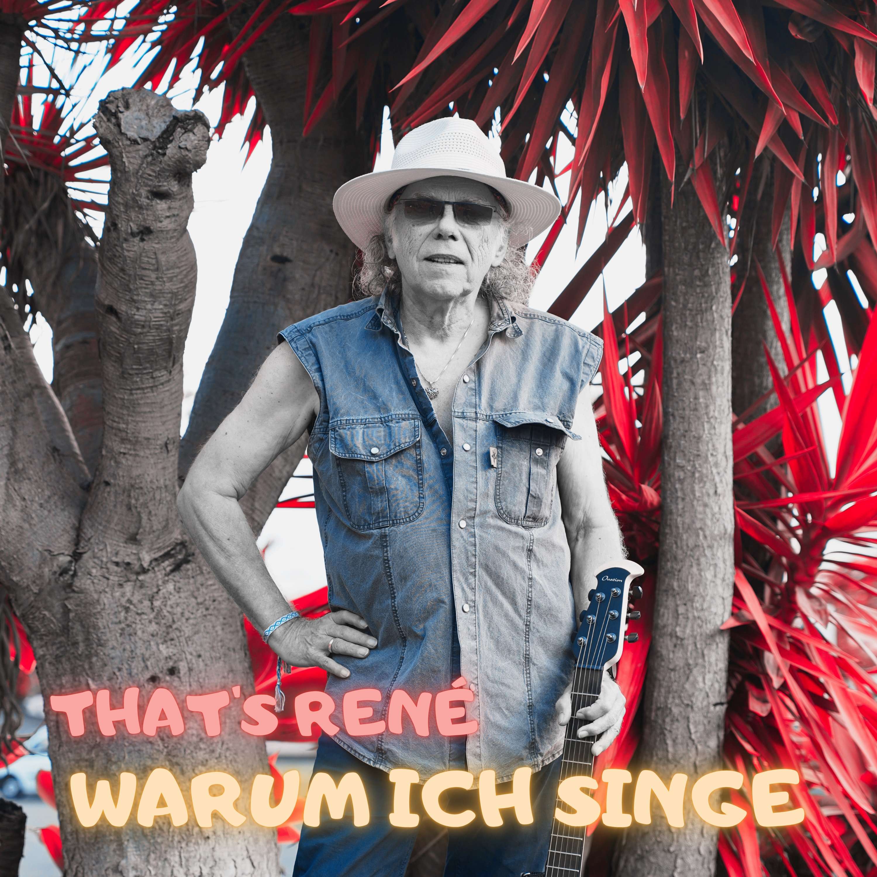 a man in a hat is standing in front of a tree